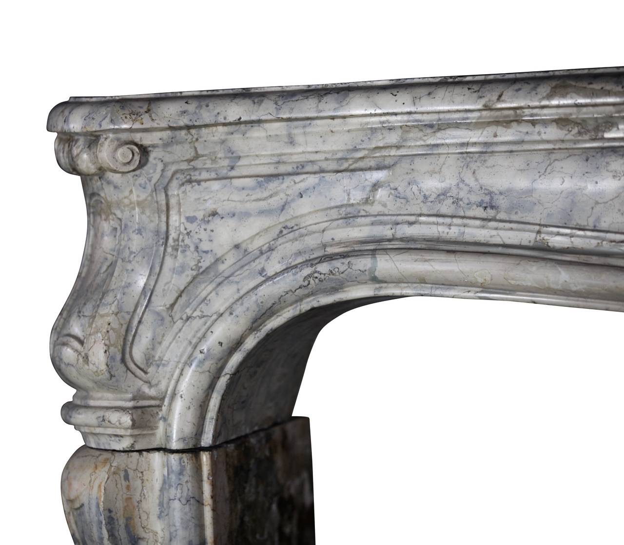 This is a very unique marble-hardstone original antique fireplace surround. The hardness of the stone reflects the light in the room. Only a few mantels were carved out of this kind of marble. All of the mantels in our inventory, in this particular
