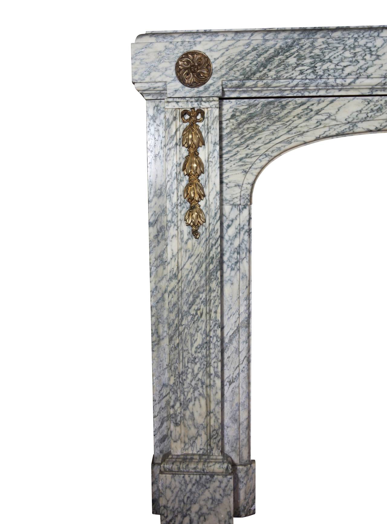 The combination of the 20th century Campan vert marble with brass and the craftsmanship is an example of the Belgian arts and the industry. This mantel (fireplace) was installed in an Art Deco house in Brussels. The veining of the marble was