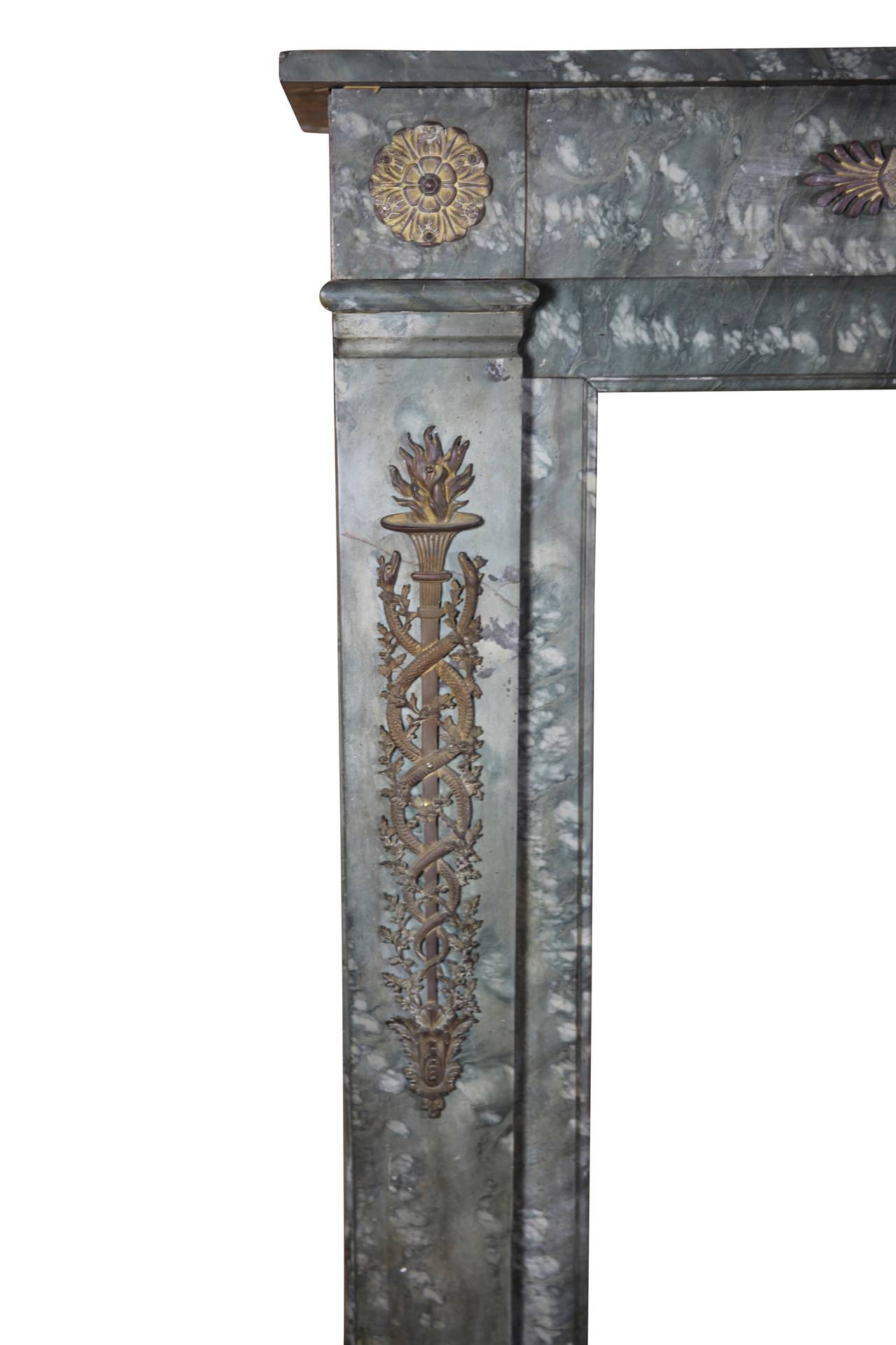 This unusual antique fireplace surround was crafted at the end of the 18th century. It is made of a very special colored marble with brass bijouterie; it is typical of Directoire period.
Amazing piece for an amazing bespoke signature home decor. It