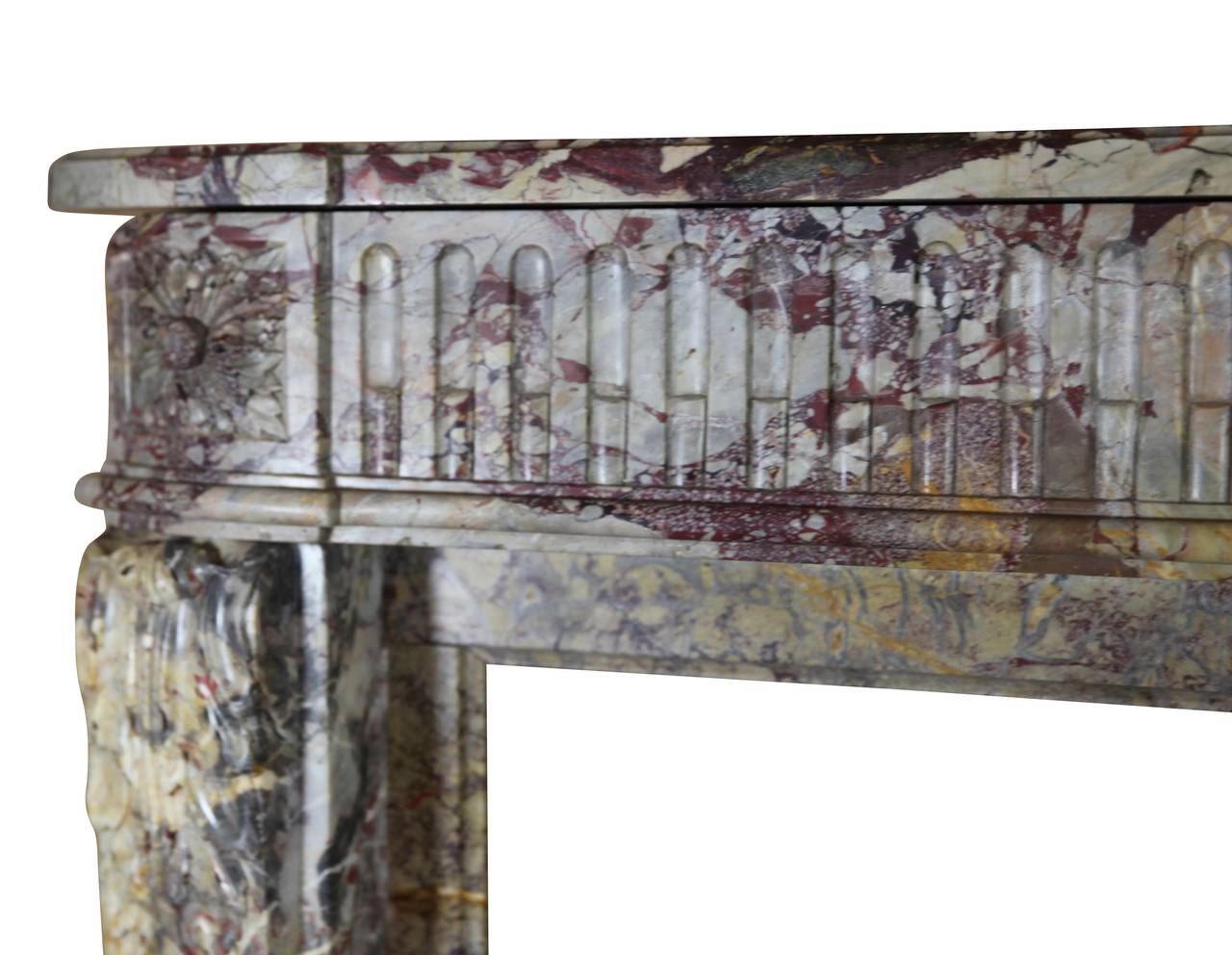 This original 18th century Royal French Saracolin marble fireplace surround is from the Louis XVI period. It has rounded corners and an exceptionally rich and brilliant color combination. The mantel is in perfect condition. It is stunning and