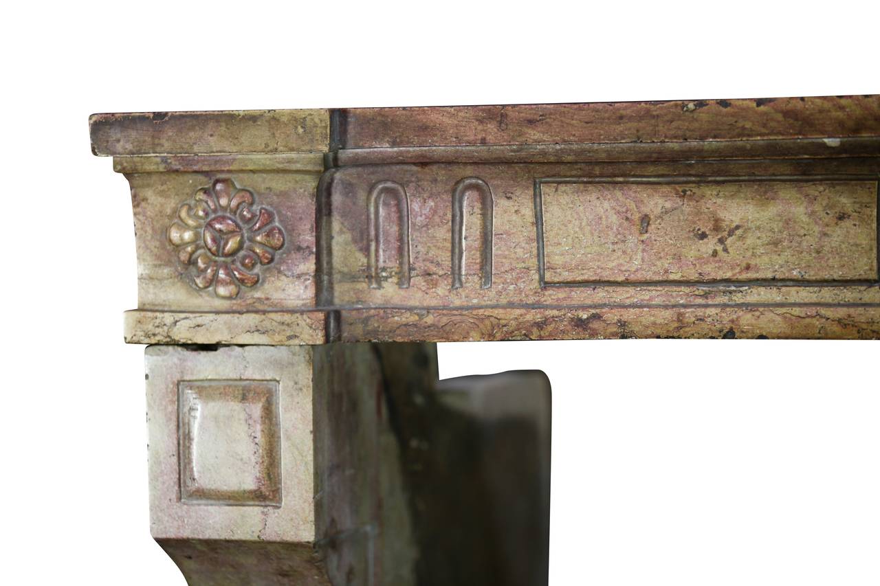 Stone designed by nature still carrying some nice patina. This original fireplace surround is from Corton, near Dijon; its French Burgundy marble stone is very typical of the region. The fronton and the jambs are one solid block. The Burgundy stone