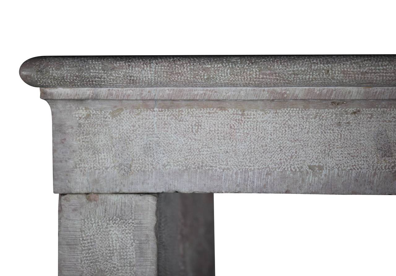 This is a small rustic, country Burgundy hard stone fireplace mantel (fireplace) with small polychrome remains. The stone is boucharder and taillerd and has a slight silvery pink glow.
This LXIII mantel is made out of three solid blocs in the 17th