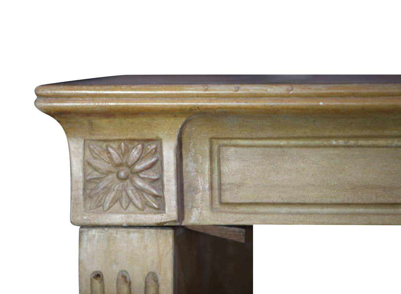 This fine fireplace surround is finely carved in hard stoned and bears a lovely patina. The ancient surfaces reflects the light of the room.
It is a Louis XVI to Directoire style.
The mantel (fireplace) is composed of three solid blocks easy to