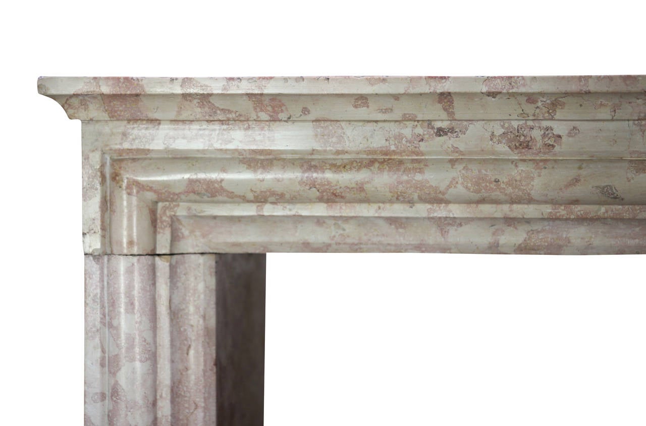 This is a Louis XIV style fireplace mantel (fireplace) with original oxidation and patina. It was installed in a small room in Dijon. The Burgundy colorful marble stone has been used in a lot of historical buildings all-over the world. A special