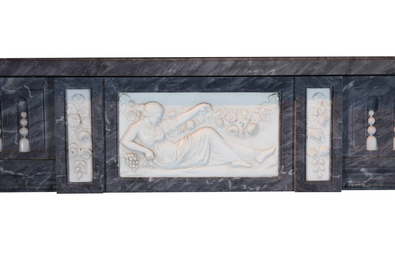 This unique original vintage fireplace surround is composed of Bleu Turquin marble with White Statuary marble. Its provenance is a Bruges Patrician house. It is off the end of the 18th century and is still in exceptional condition and not at all