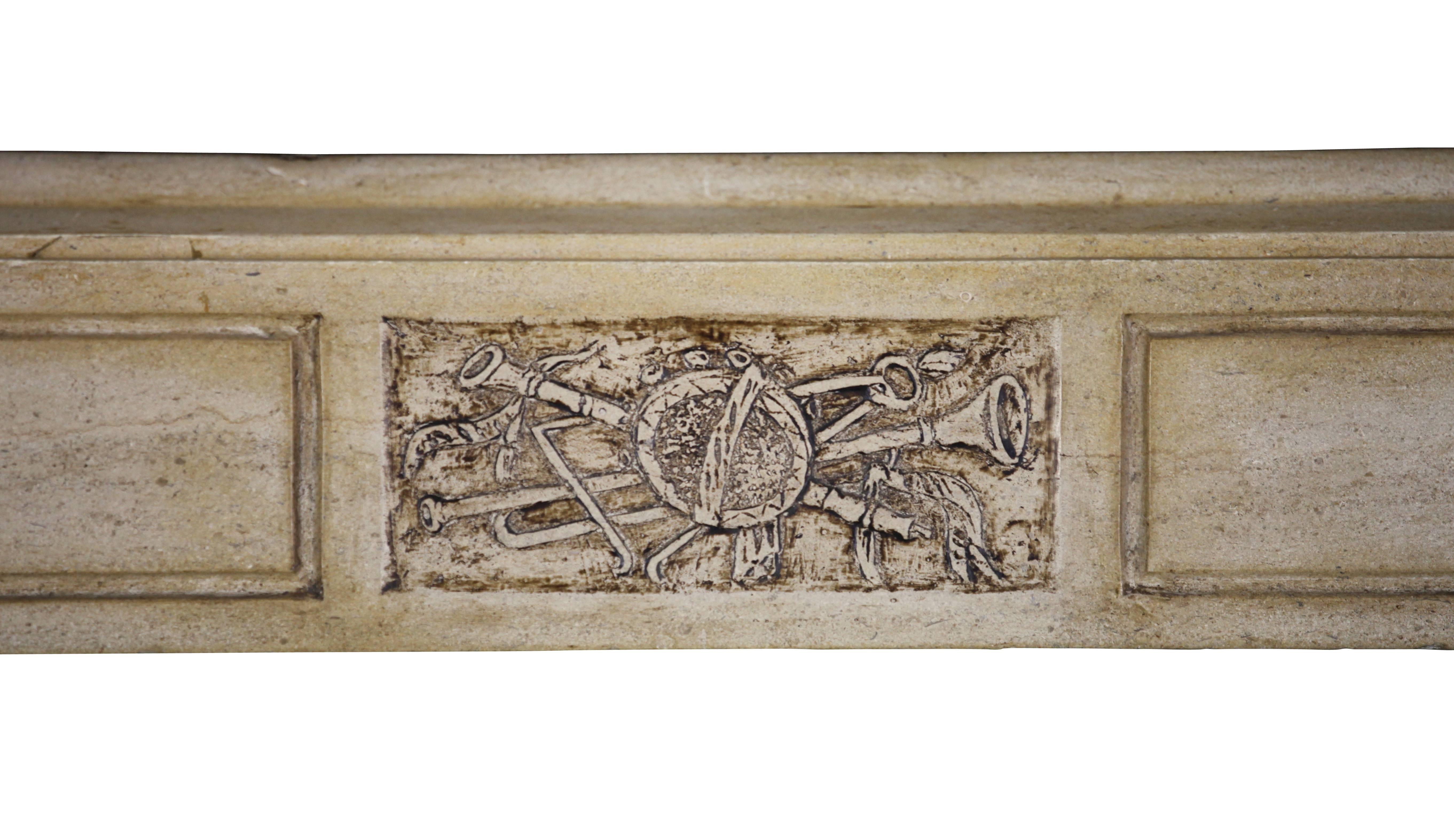 Authentic fireplace surround from the Burgundy region with amazing  cartouche in the center of the fronton: Details of music instruments. This mantel has also a very nice patina. 
Measurements:
140 cm Exterior Width 55,13 Inch
108 cm Exterior Height