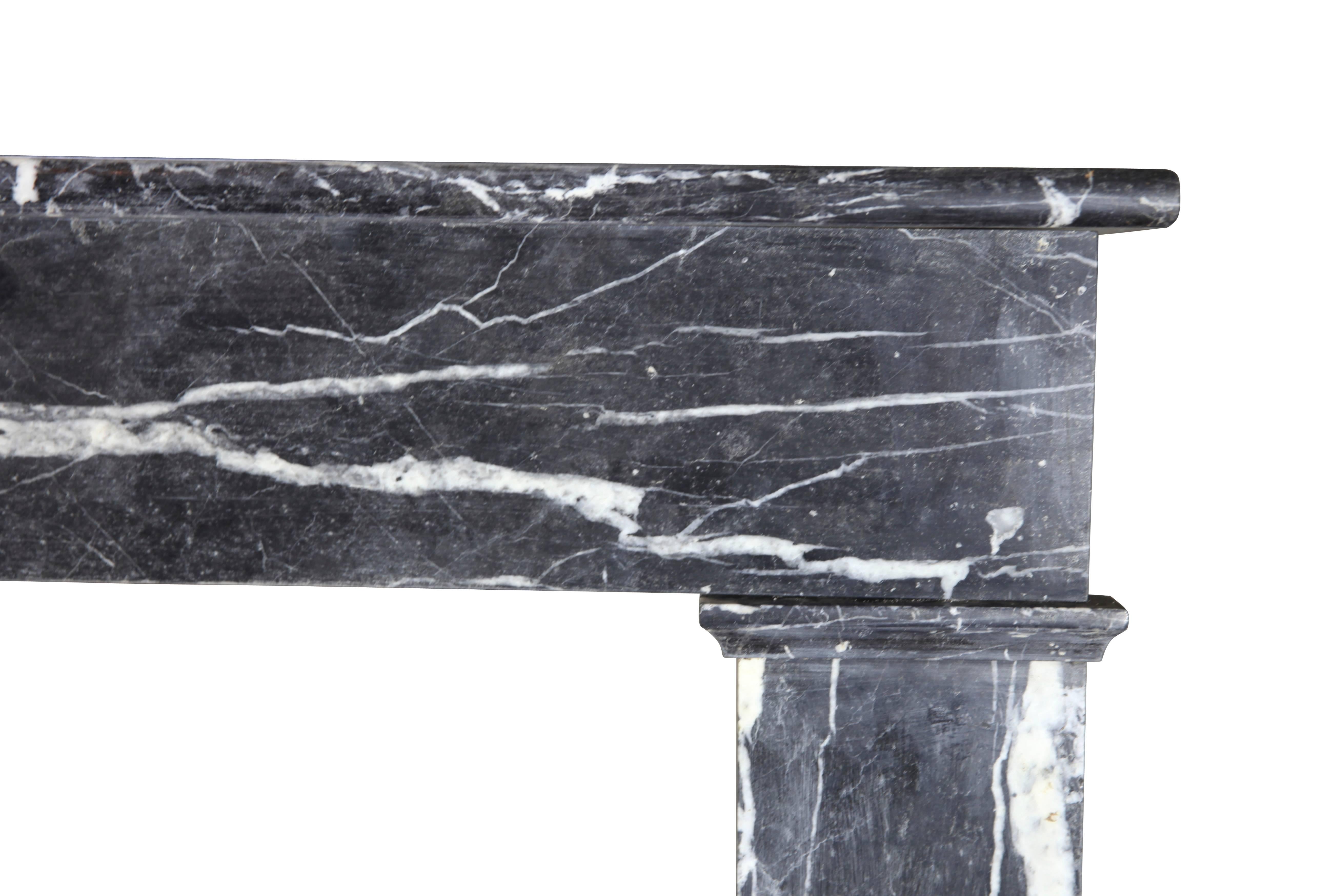  A Louis Phillippe period antique fireplace surround in gleaming dark St-Anne marble.  

Measures: 
125 cm EW 49,21"
101 cm EH 39,76"
97 cm IW 38,18 "
88 cm IH 34,64"
32 cm S 12,59" 