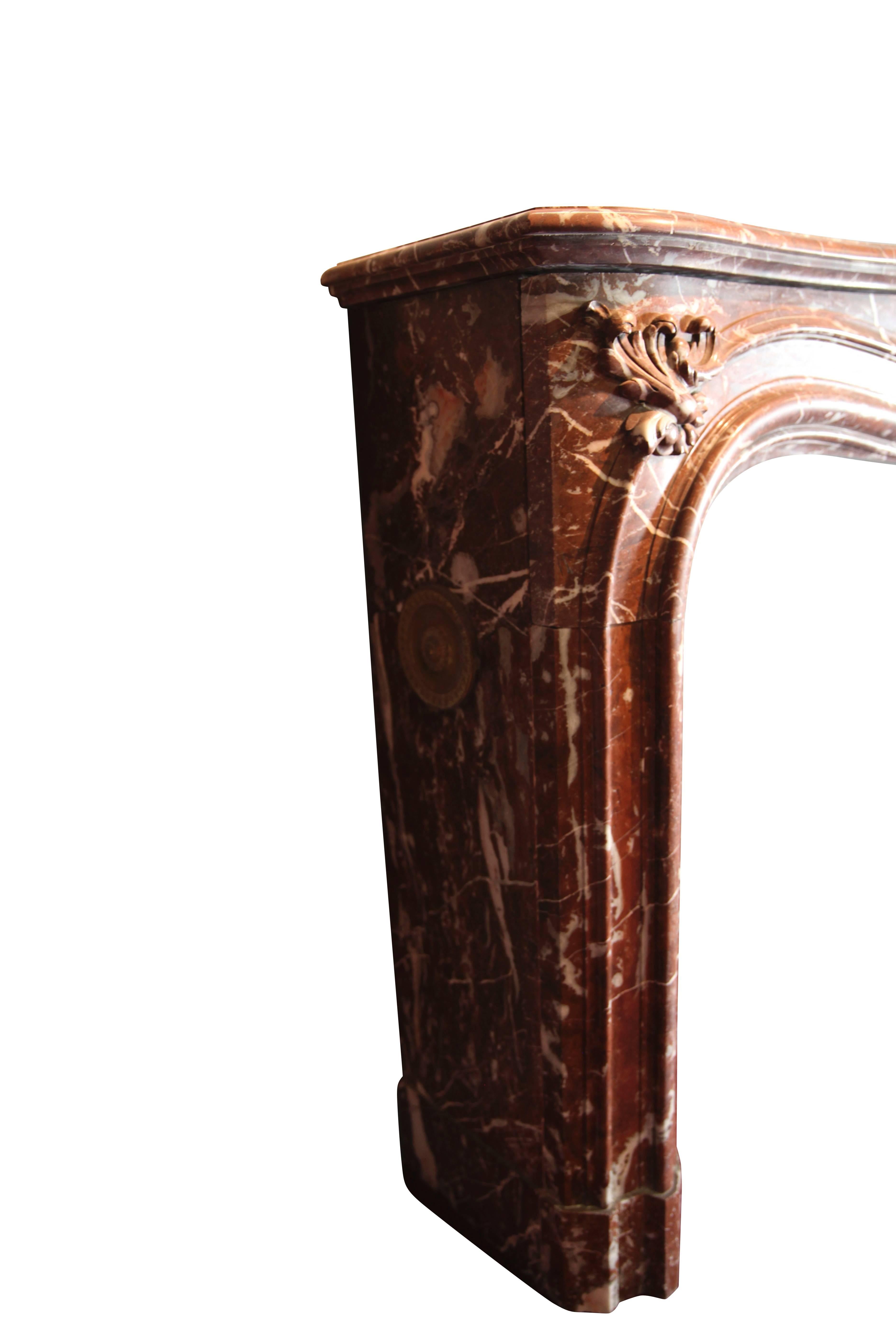 This is a Belgian red marble Regency style fireplace surround.

Measures: 
167 cm EW 65,75"
117 cm EH 46,06"
124 cm IW 48,81"
94 cm IH 37"
43 cm S 16,92"