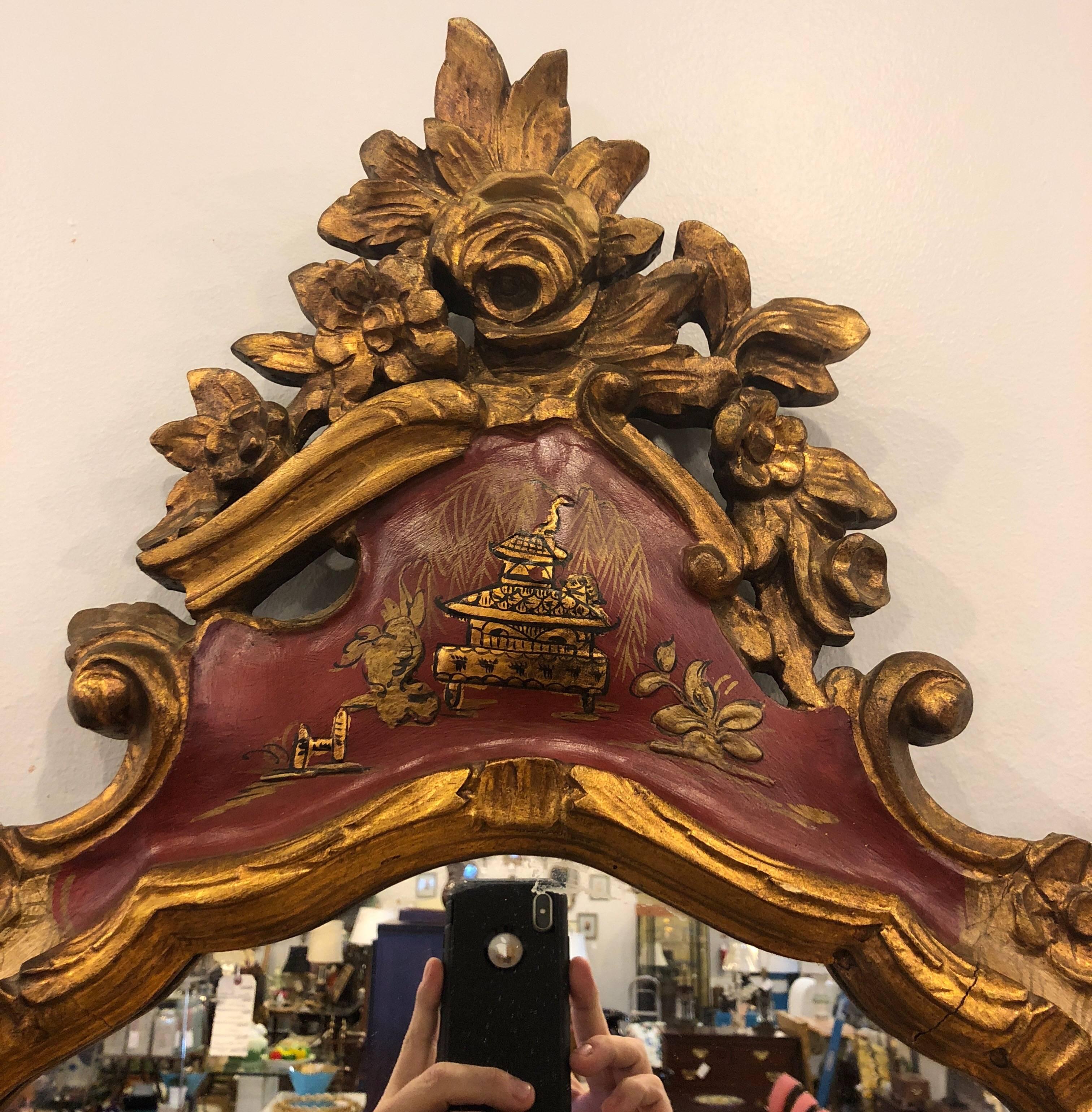 Fabulous chinoiserie and gilt Italian wooden mirror creating a commanding presence in any space. No cracks to wood and no repairs.