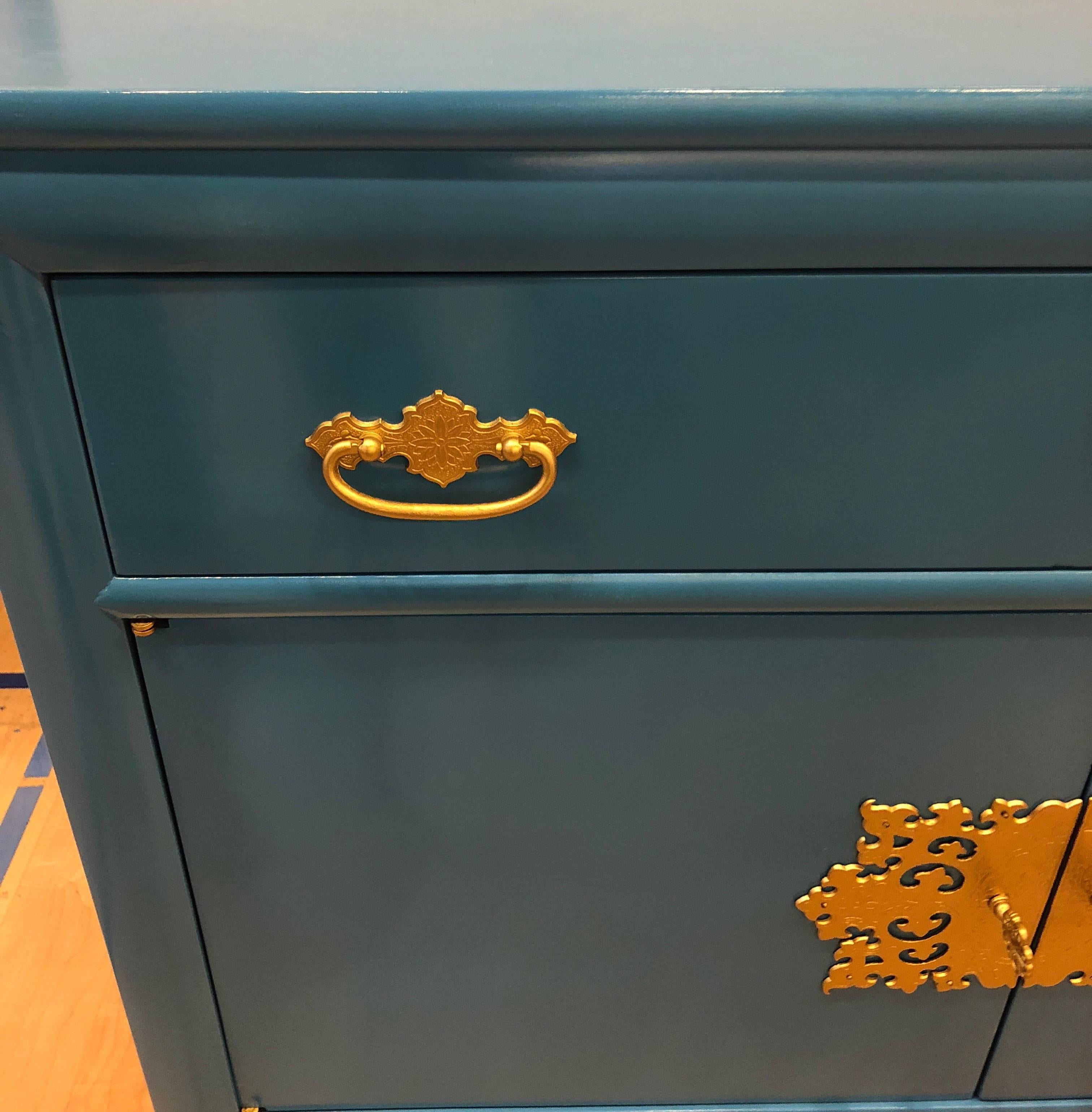 A excellent piece in Asiatic blue lacquered in perfect condition. Hardware done in a gold lacquering finish as well. Made by Century Furniture. Would be perfect for a vanity in a Asian themed bathroom or powder room.