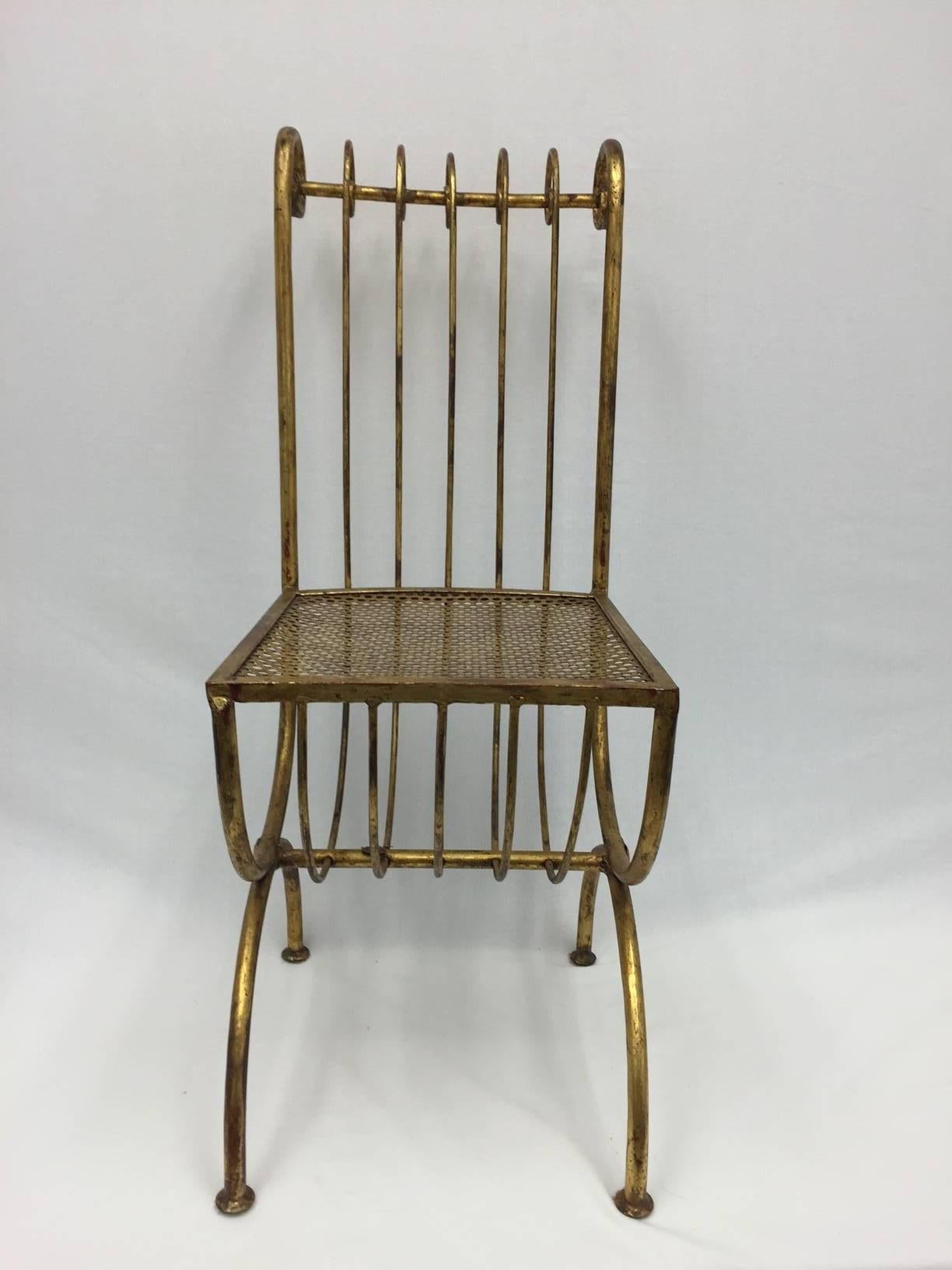 This stunning chair is in perfect vintage condition with little wear.  It presents a striking silhouette and doubles as a work of sculpture art. The finish is patinated nicely, revealing glimpses of red beneath the gilt.  It is a stand alone piece