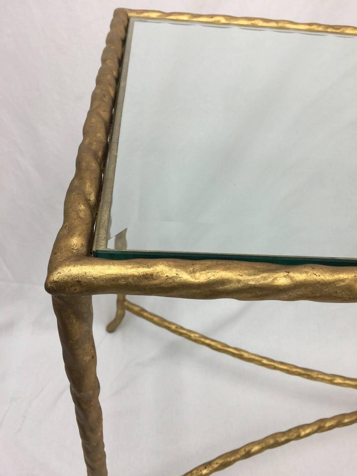 This table is the perfect simple grace note for your foyer or behind your sofa.  Beveled glass, simple cross bars, all made from the same gold metal rope.  This piece will complement any interior style from traditional to asian, to contemporary.