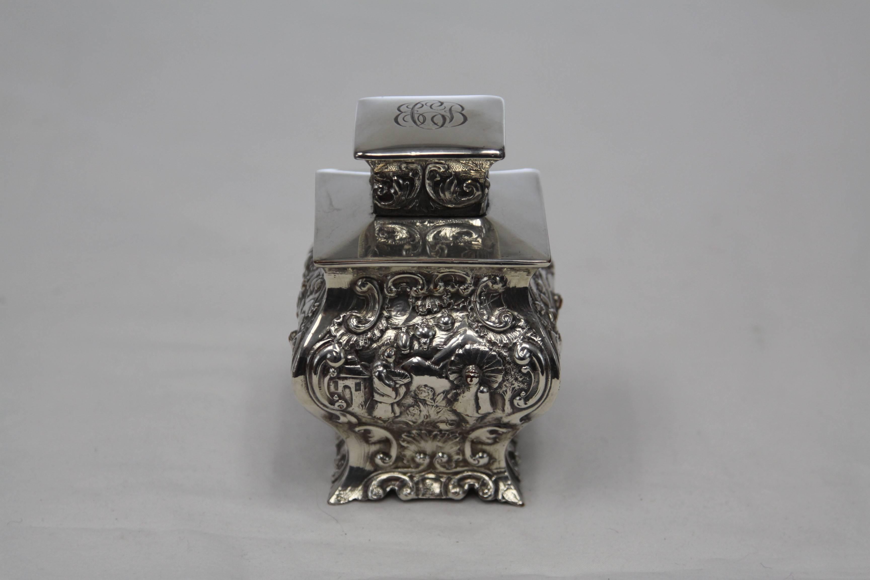 This tea caddy is heavily detailed and engraved with asian designs. It is monogrammed EBC on the top. Made from Sheffield silver on copper. Great detail in excellent vintage condition with minor signs of wear and age.
