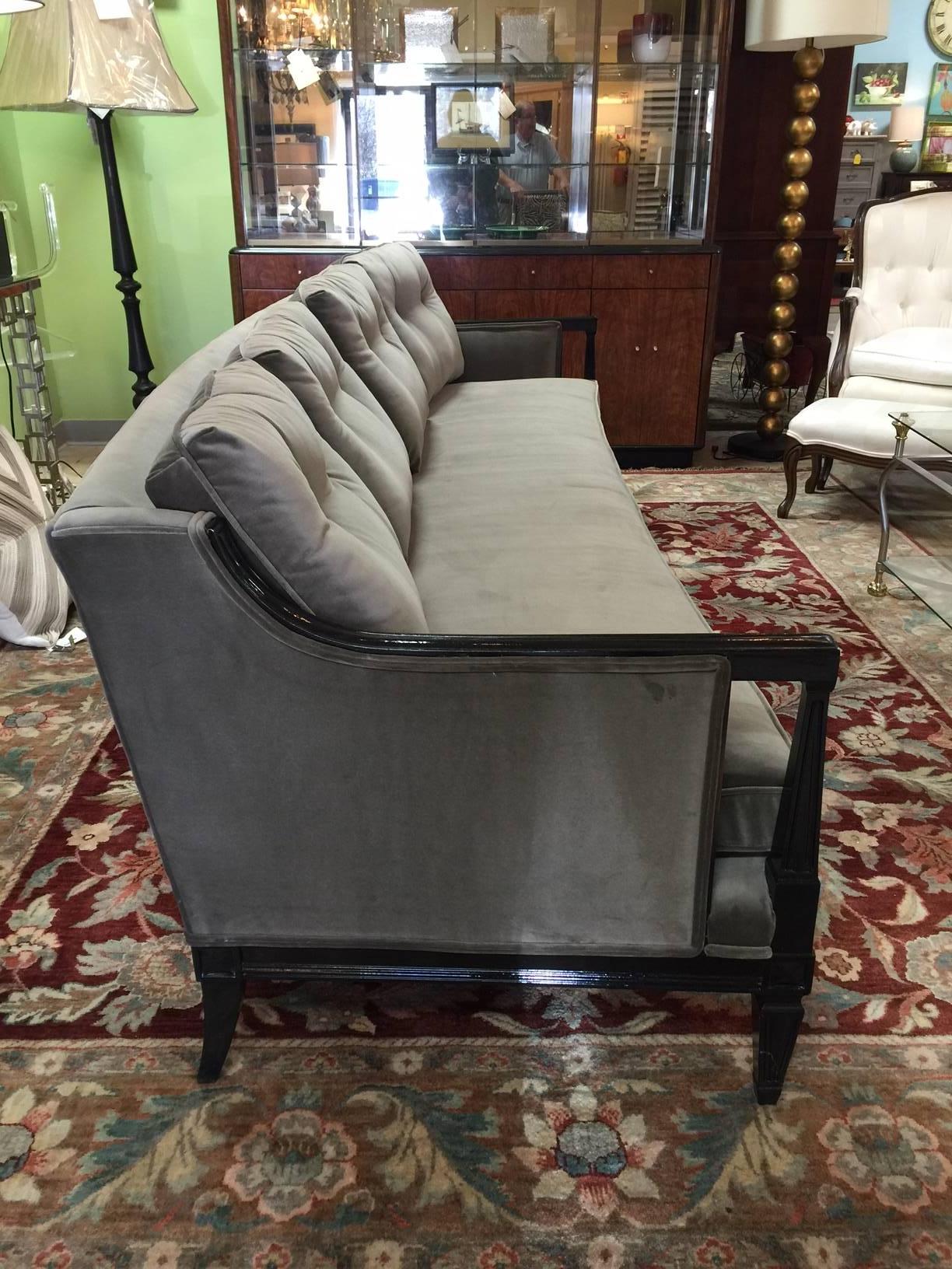This long and lean sofa is covered in a gorgeous velvet that is a cross between olive and taupe. The seat has a new foam core and is wrapped in down and the back cushions are also down with a new wrap. The frame has been lacquered black. Designed by