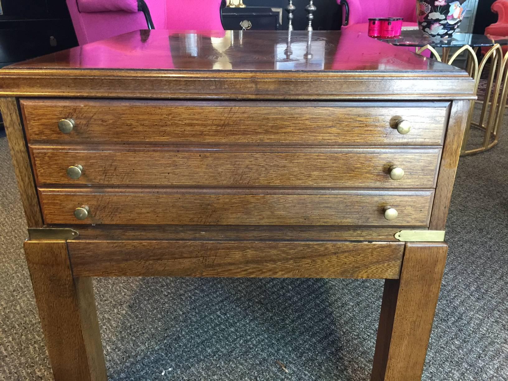 This Mid-Century side table is in excellent vintage condition with a beautiful burled top, a single drawer and brass corner fittings and feet.