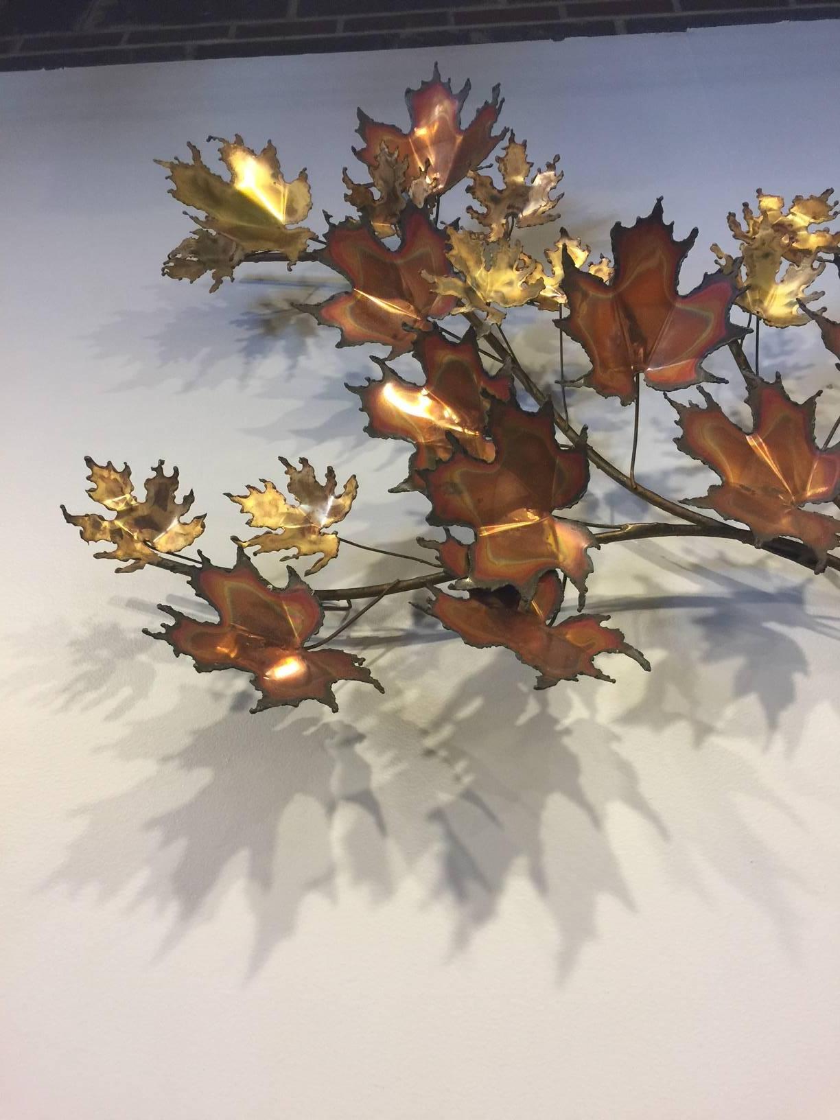 This spray of maple leaves is signed C. Jere and is made of copper and brass. The leaves are burnished bringing various hues to the piece. Sturdy hangers on the back. Measurements are for the widest dimensions.