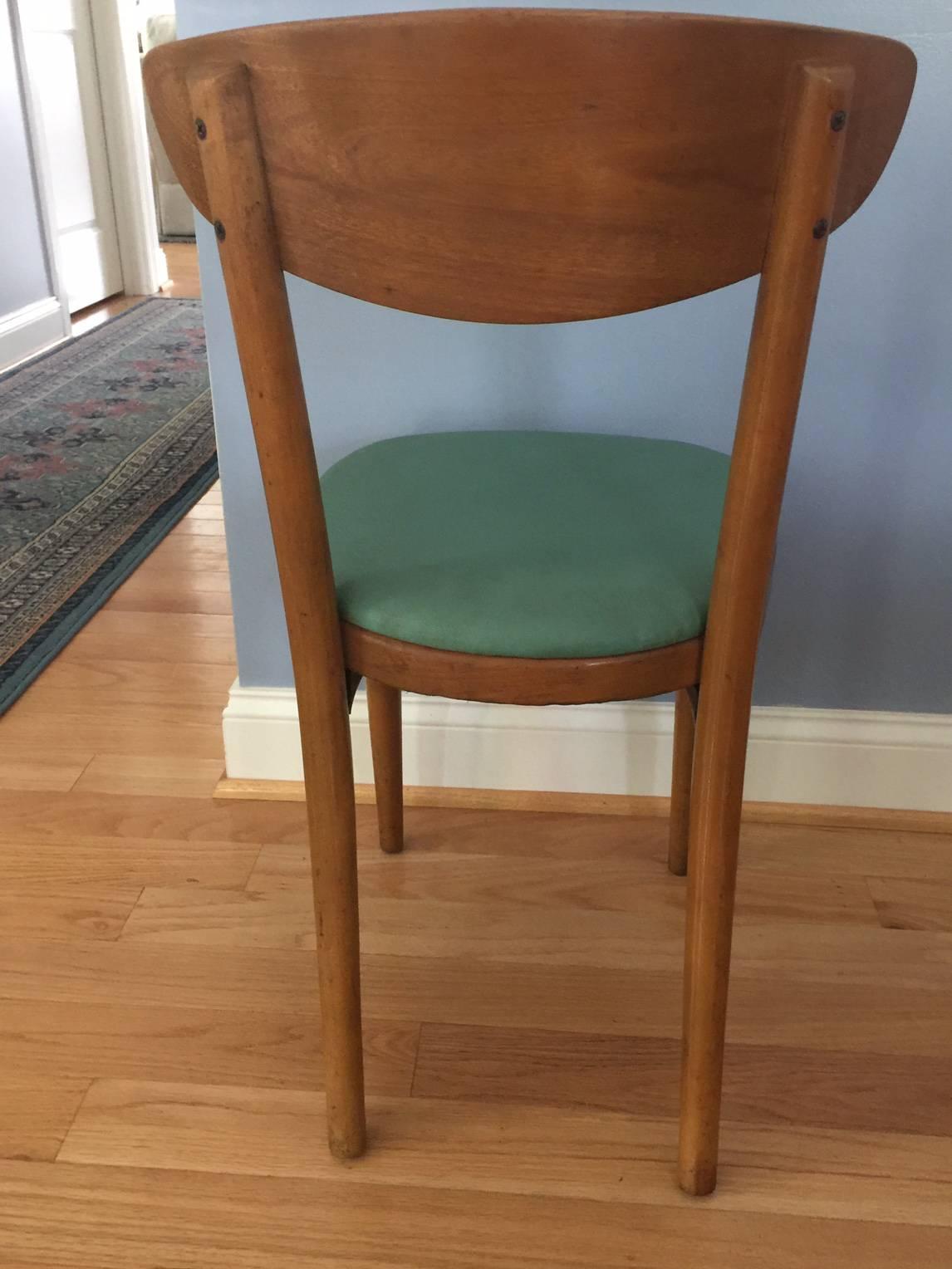 These chairs are labeled as manufactured by Thonet and also have a label (partially shown in one photo) of Knoll. They were probably manufactured in the 1930s and originally had a felt upholstery, which was subsequently replaced with the green vinyl