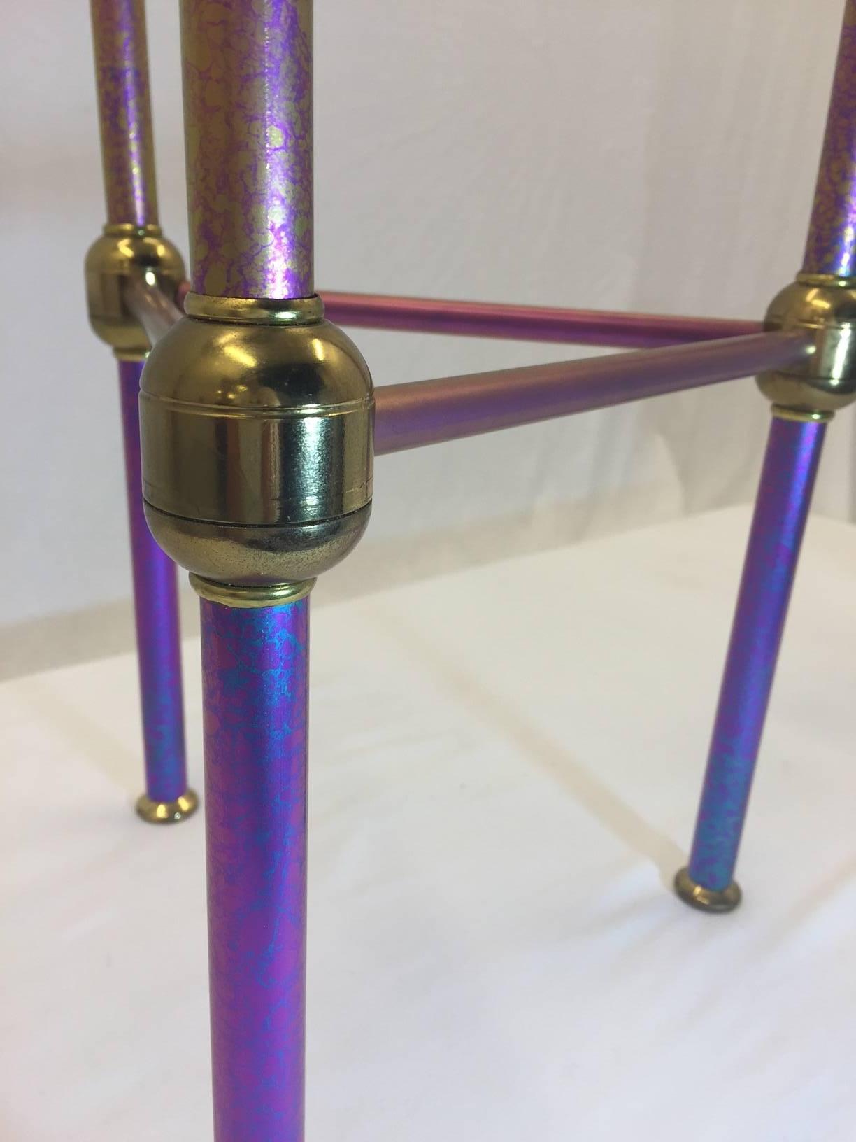 This piece was brought to us as a Specter candlestick holder created as a prototype by Specter but never produced. This is a one of a kind. It is made of iridescent titanium and brings a shimmery range of colors from fuchsia to deep purple and is