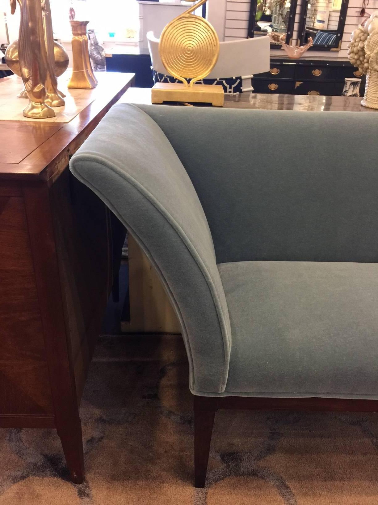 This vintage Midcentury piece has been restored to former glory. It is elegant, curvaceous, and sublime in its simplicity. Newly reupholstered in a plush mohair in a dusty teal shade.