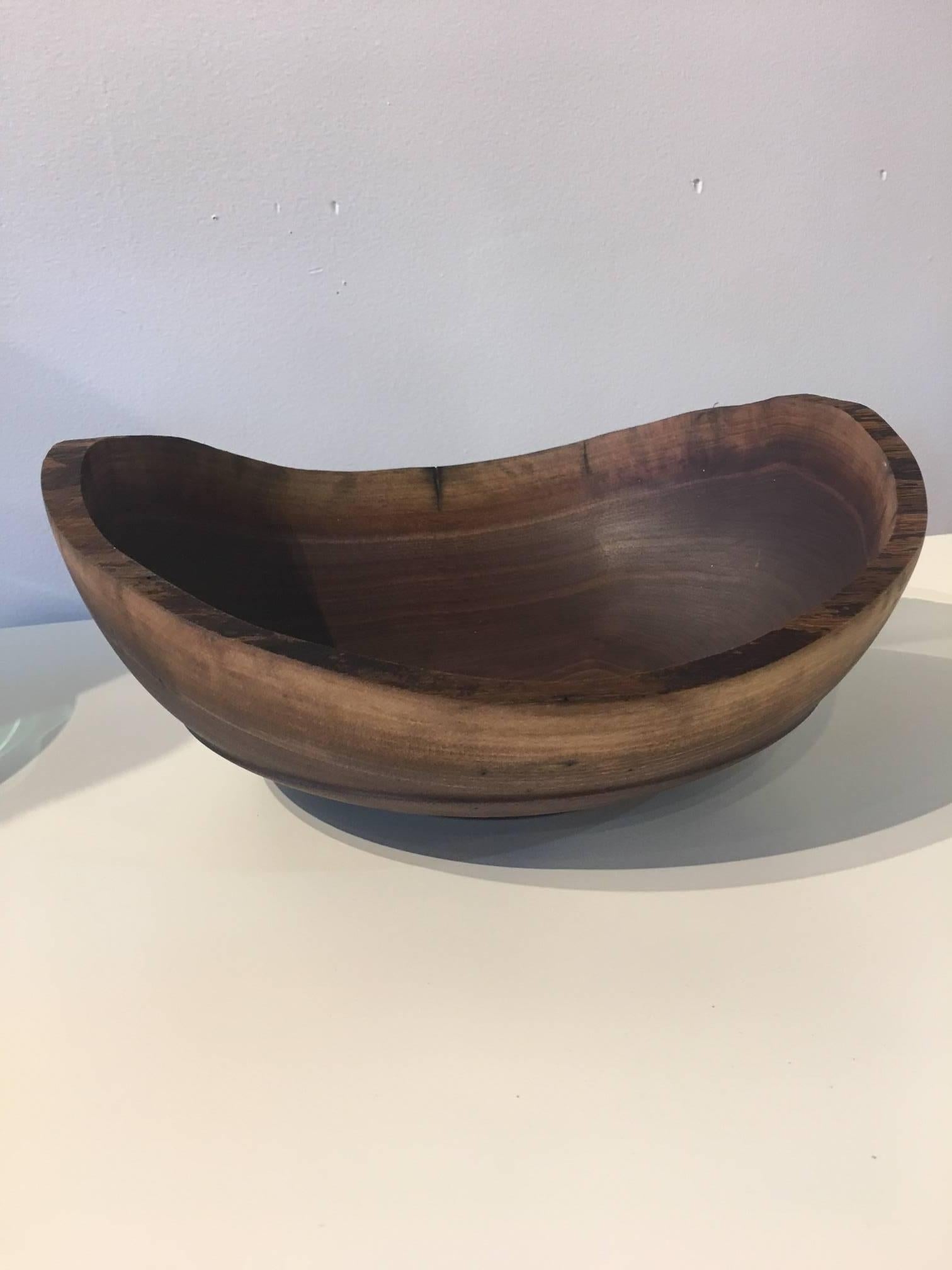 Gorgeous walnut bowl with raw edges and irregular shape is a utilitarian piece of art to grace your table or your collection. Richly colored with great natural variations, this piece is a stunner. Hand made in North Carolina.