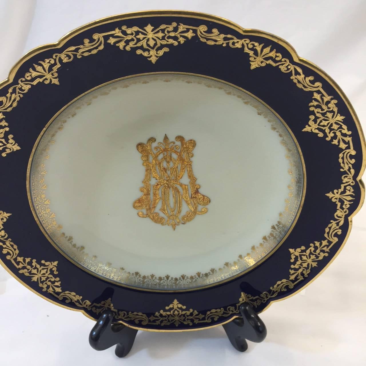 Set of five French dinner plates or bowls made by Medailles Dior, 1867-1878. Cobalt blue edge with gold design, and gold crest in centre. Each plate measures nine and three quarter inches and are marked C H Pillivuyt, Paris. All plates are in good