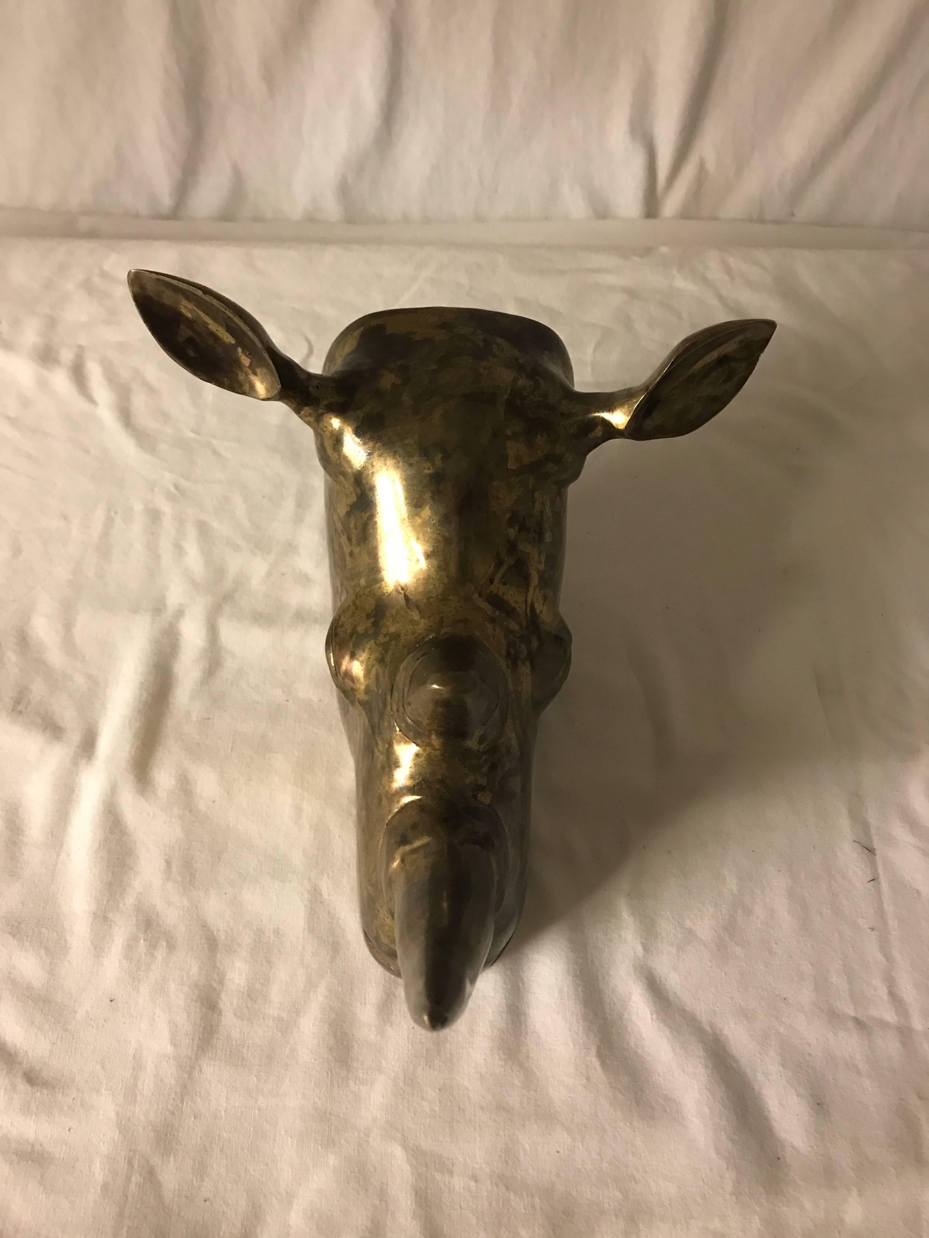 This piece is pure fun and hangs from the wall for all you big game hunters who are really not. Great mottled brass.