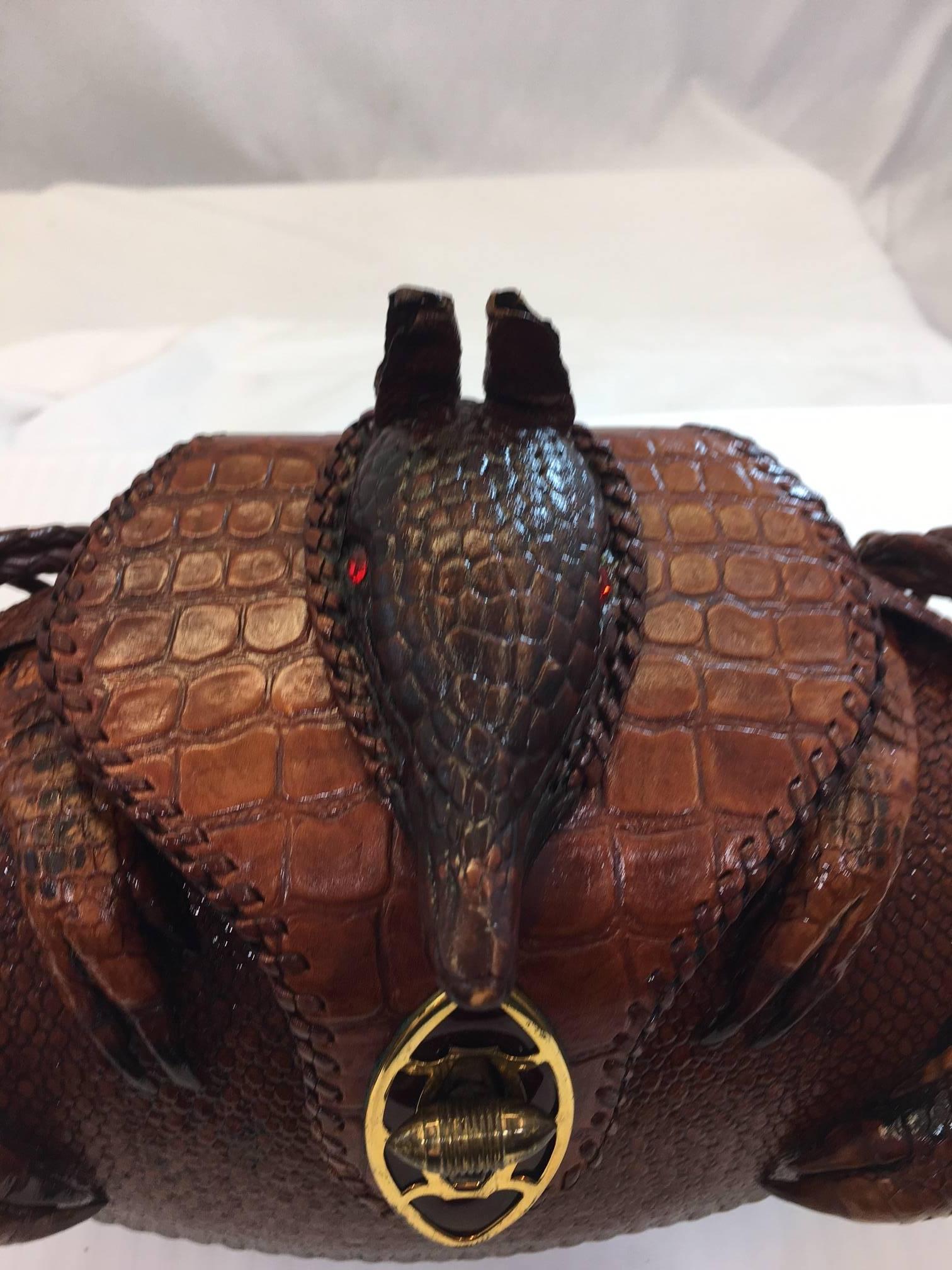 This vintage piece is a combination of taxidermy and artistry and will be a conversation piece whether it is carried or used as a home accessory. The photos tell the story, it is in excellent condition with all pieces intact, red jewels as eyes, a