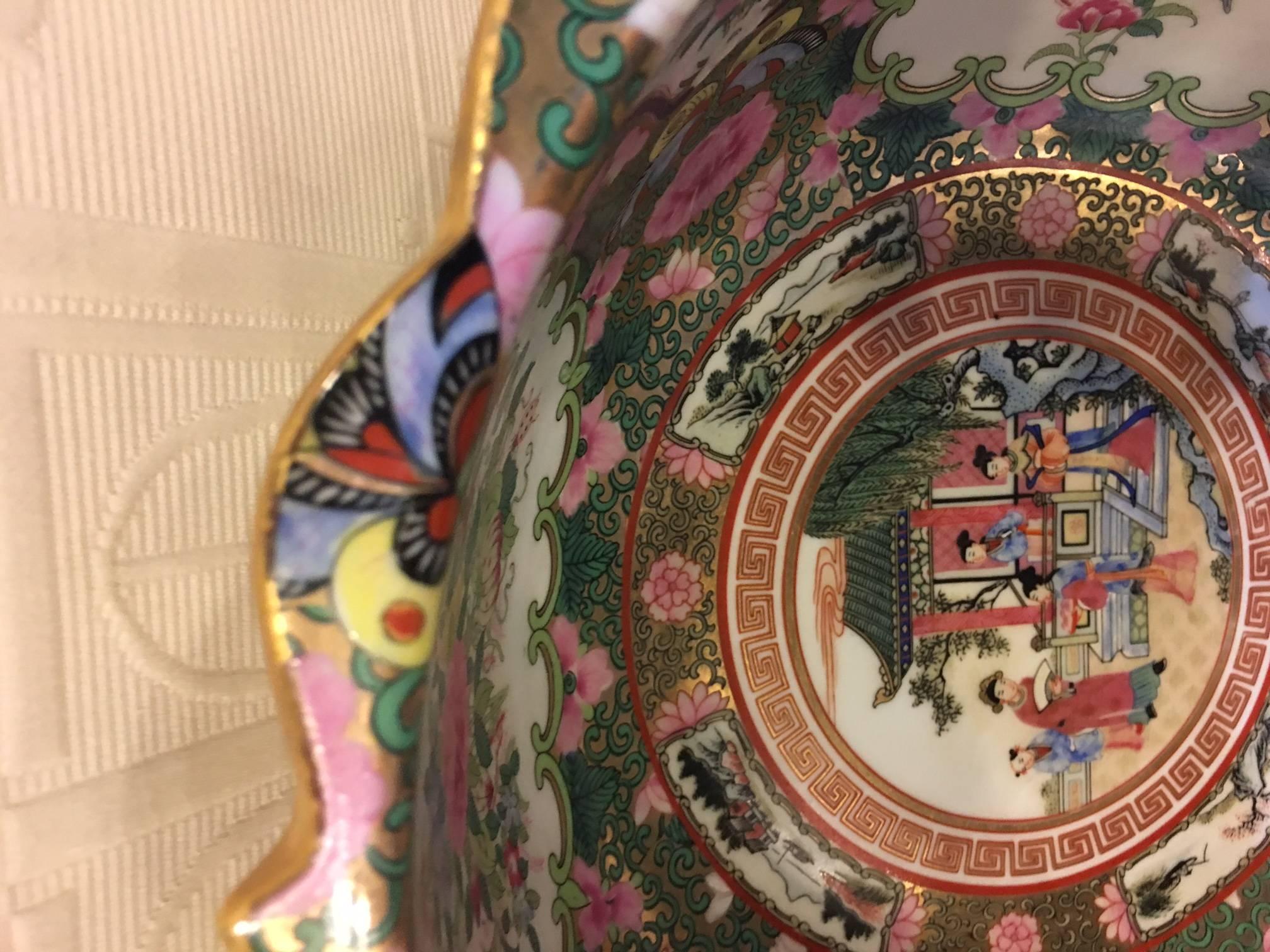 This is a late 20th century Chinese Canton style 'famille rose' enameled porcelain punch bowl (sometimes also called 'Rose Medallion'. The mark on the foot is a decorative version of a Qianlong reign mark. Scalloped gold edged rim.