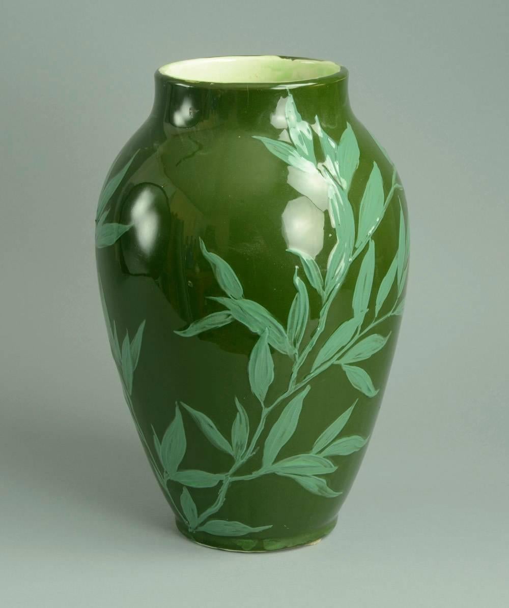 Porcelain vase with hand-carved foliage decoration in light relief and hand-painted in pale green glaze over dark green background. High gloss finish, circa 1900.
Note: Five short hairline cracks to rim (only one can be seen on exterior).