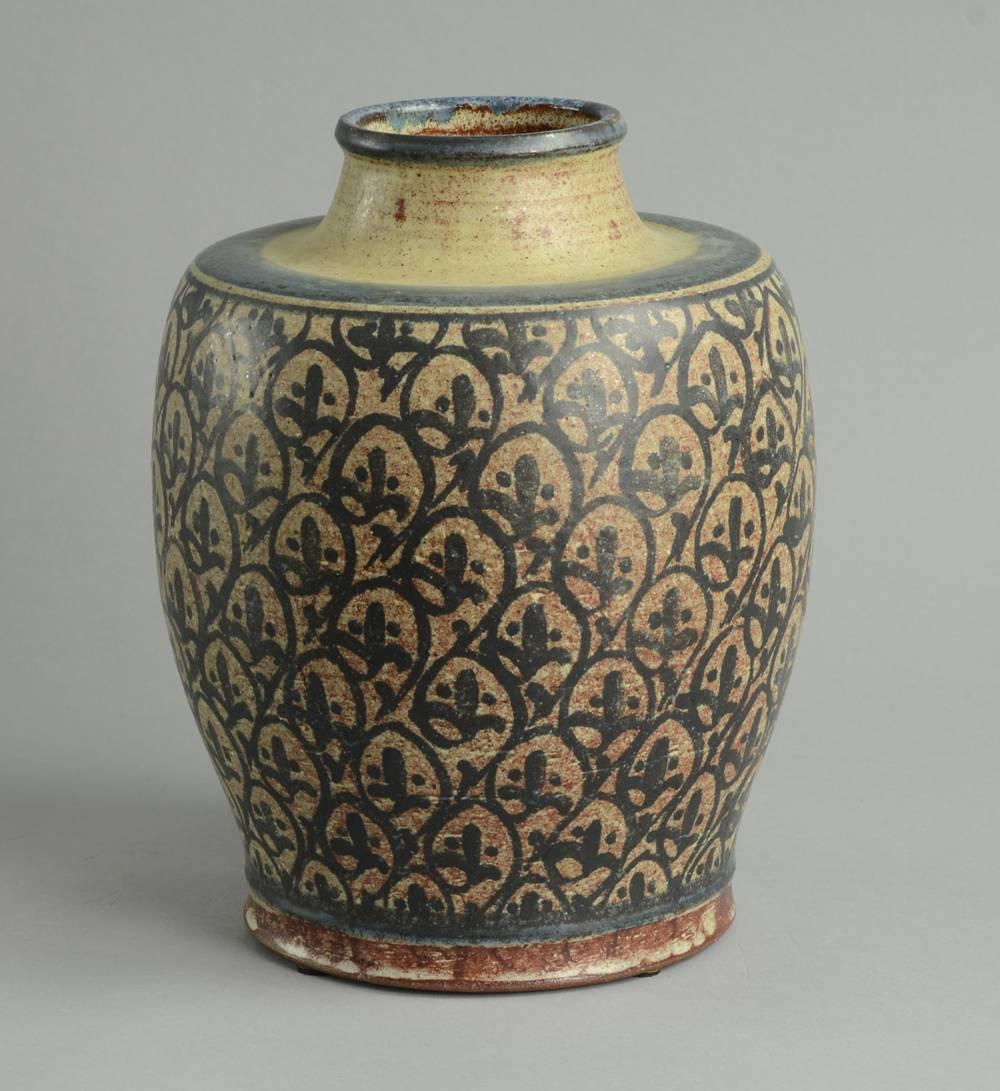 Unique earthenware vase with painted decoration in cream and blue.