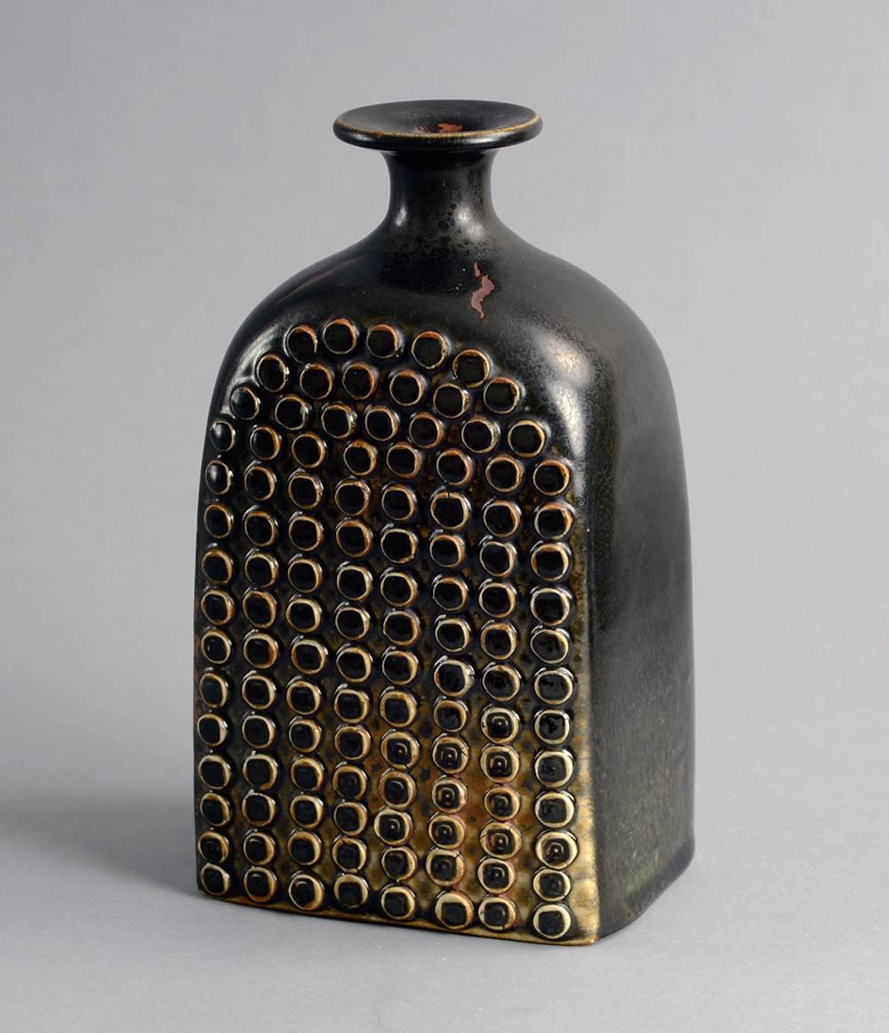 Unique stoneware vase with impressed pattern to body and semi-matte brown glaze, 1966.
 