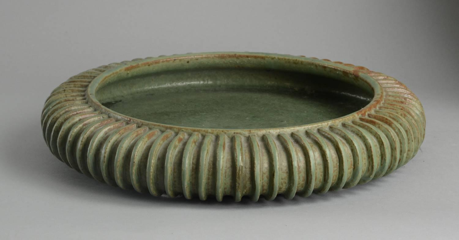 Stoneware very large ribbed bowl with matte green glaze, 1930s.
