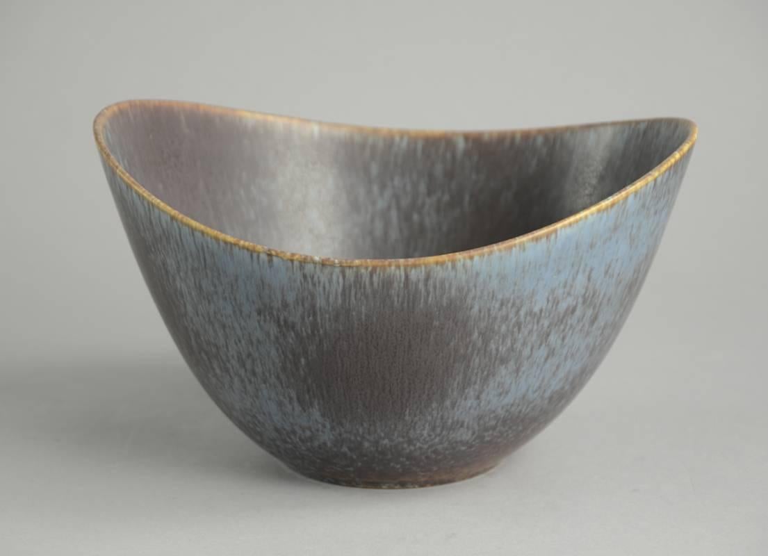 1. Stoneware bowl with matte blue and brown glaze.
Height 5" (12.5  cm), width 8" (20.5 cm) No. B3585.

2. Stoneware vase with matte blue and brown hares fur glaze.
Height 9" (23 cm), width 2 3/4" (7 cm) No. A1724

3.