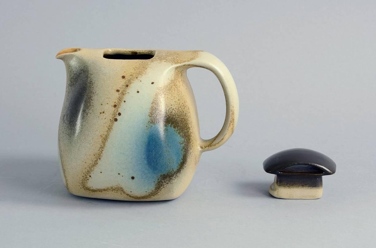 Gottlind Weigel, own studio, Germany, stoneware lidded teapot with semi-matte brown, beige and blue glaze, 2008.
Measures: Height 5 1/2