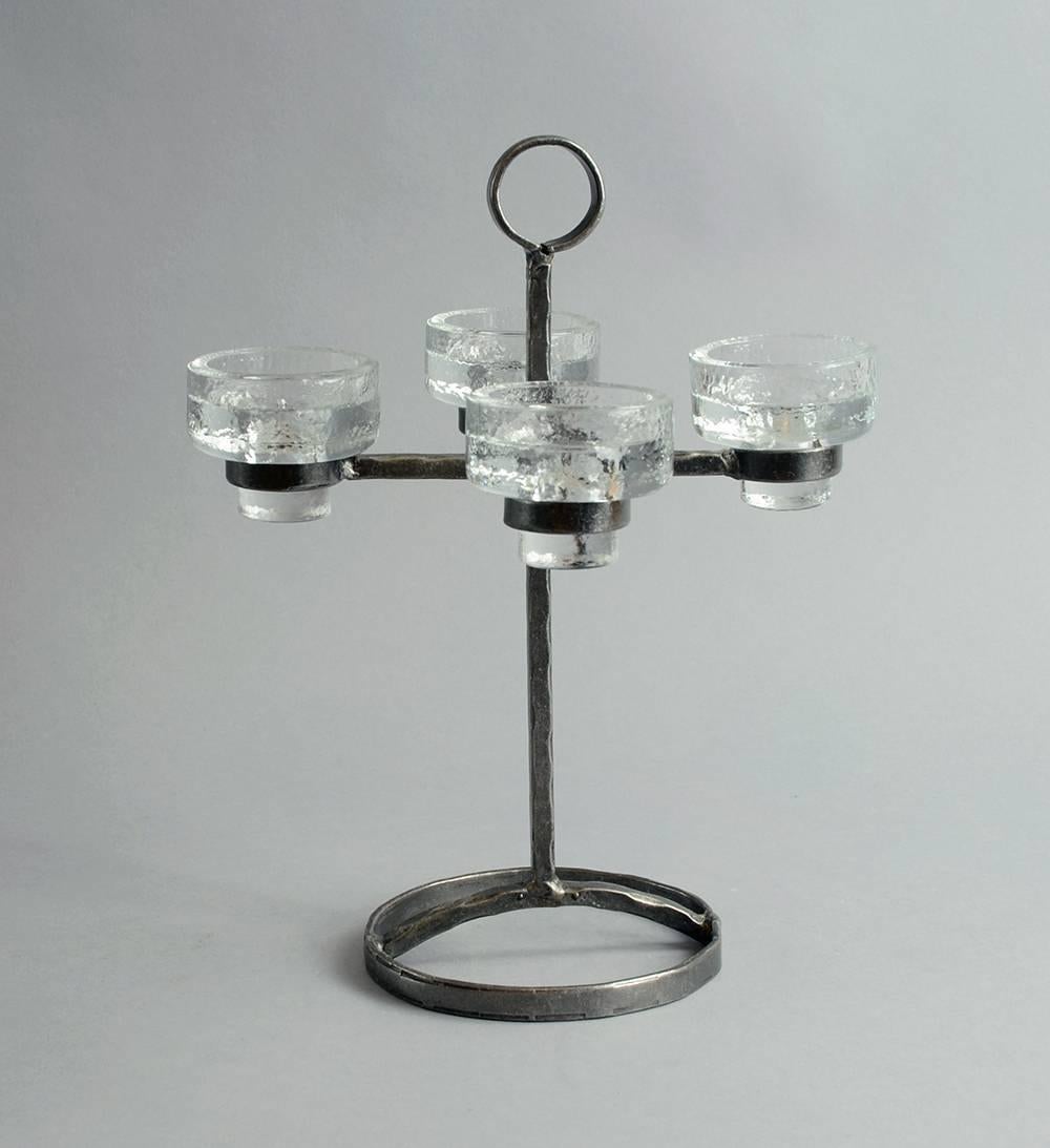 Wrought iron candlestick with four arms and four glass candle holders. Can hold standard candles or tea lights. Made in Sweden, 1960s.
Measures: Height 11 3/4" (30cm) width 9 1/4" (23.5cm).
Impressed "MADE IN SWEDEN" No.