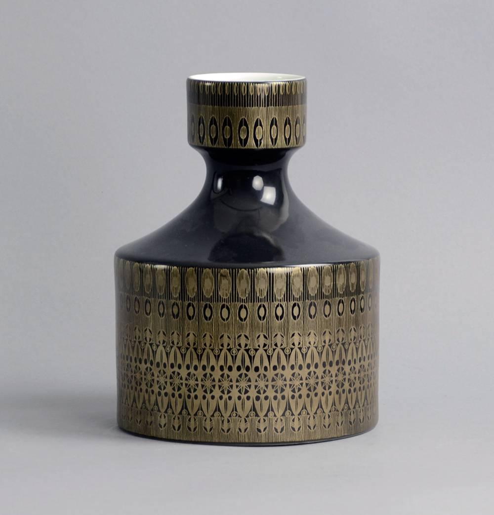 

1. Porcelain vase with glossy black and white glaze with gold line decoration to exterior, by Hans Theo Baumann for Rosenthal, Germany, 1960s.
Height 8 1/4