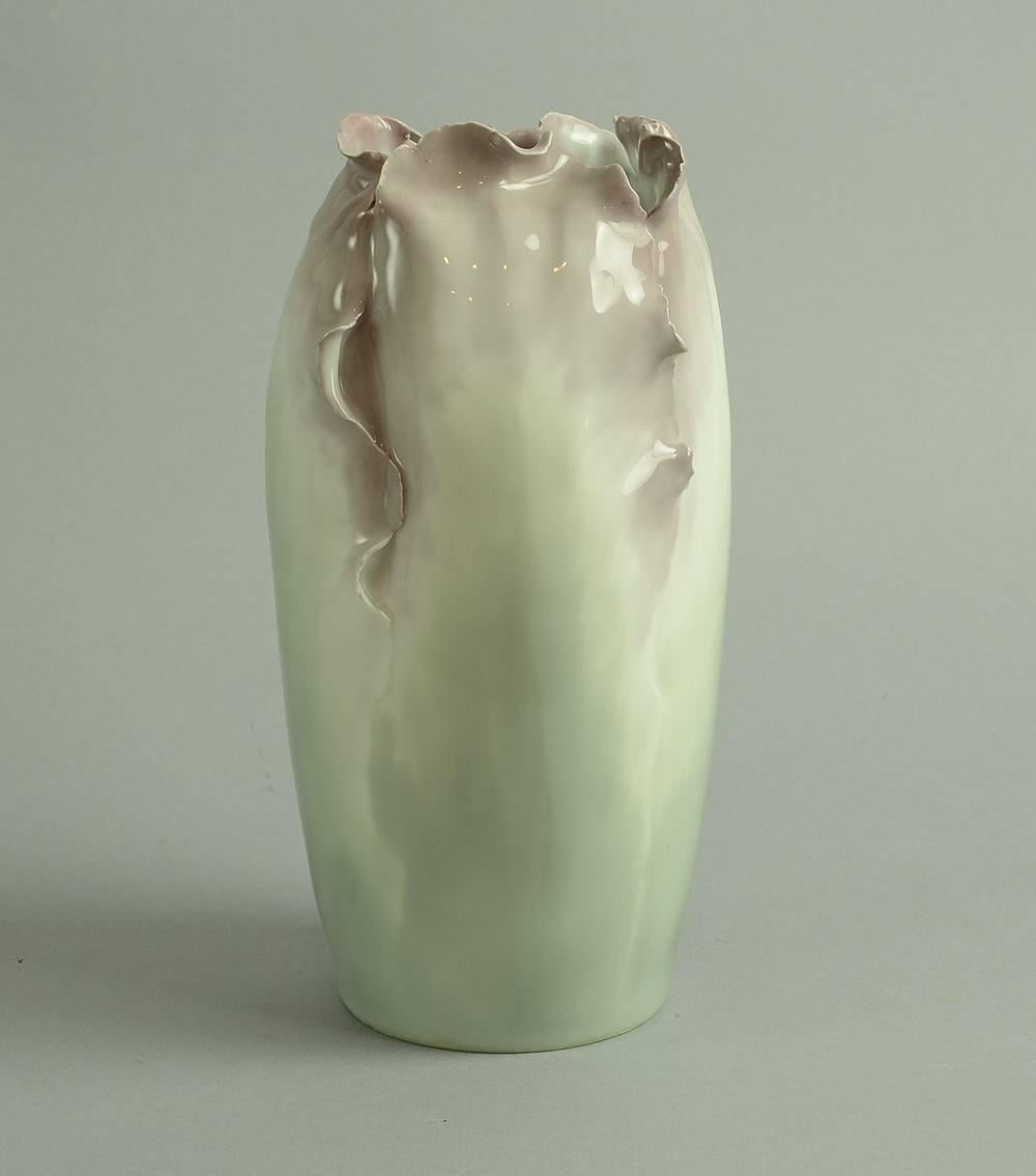 Porcelain vase with hand molded and carved body and opening, glaze in pink, white and grey, 1910s-1920s.
Note: some flakes to carved edges, under the glaze (done in the making).
Measures: Height 10 1/4