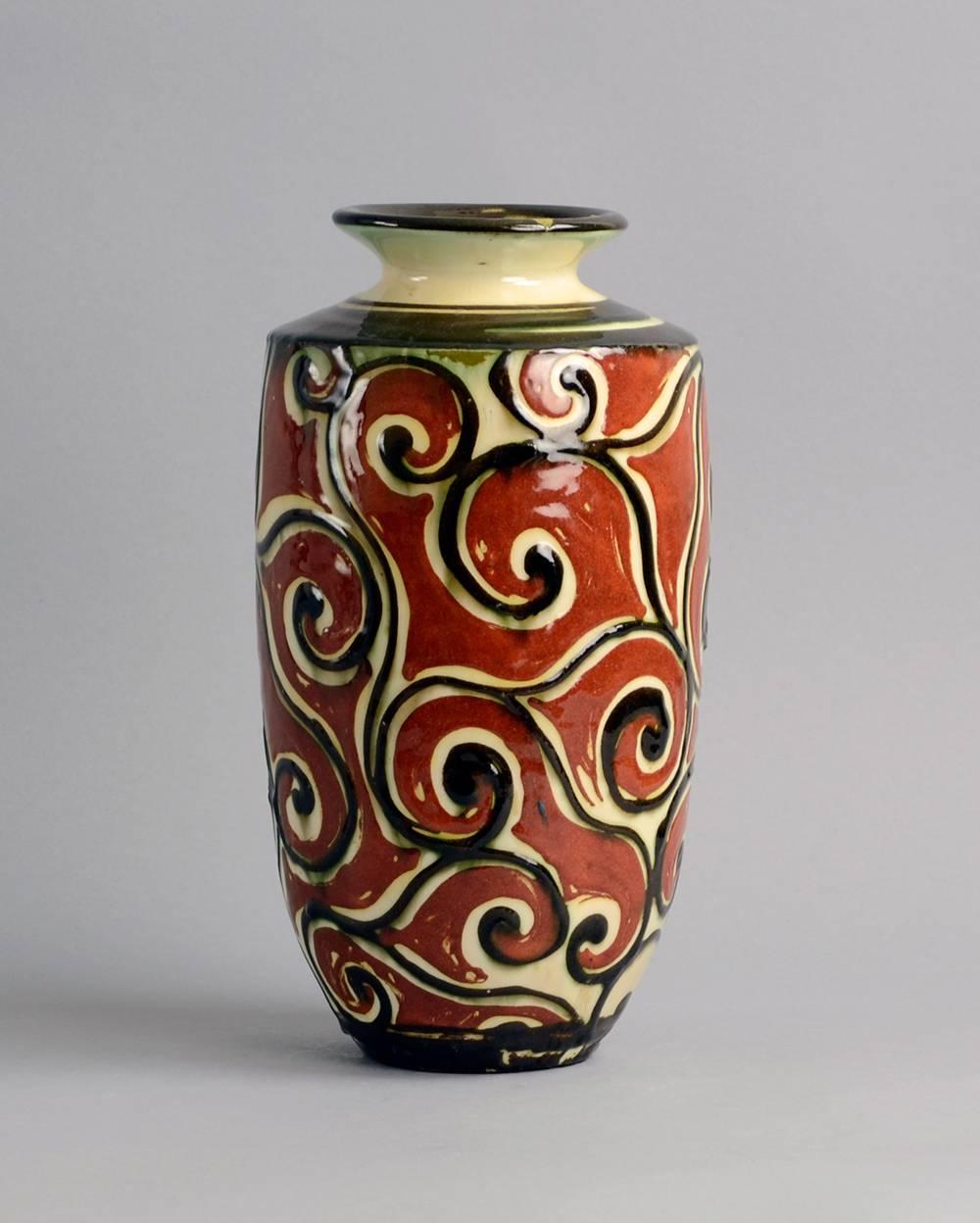 Sophie Lundstien for Herman A. Kahler Keramik.
Stoneware vase with hand-painted decoration in glossy red-brown, dark brown and cream glaze, 1920s.
Measures: Height 10 1/2