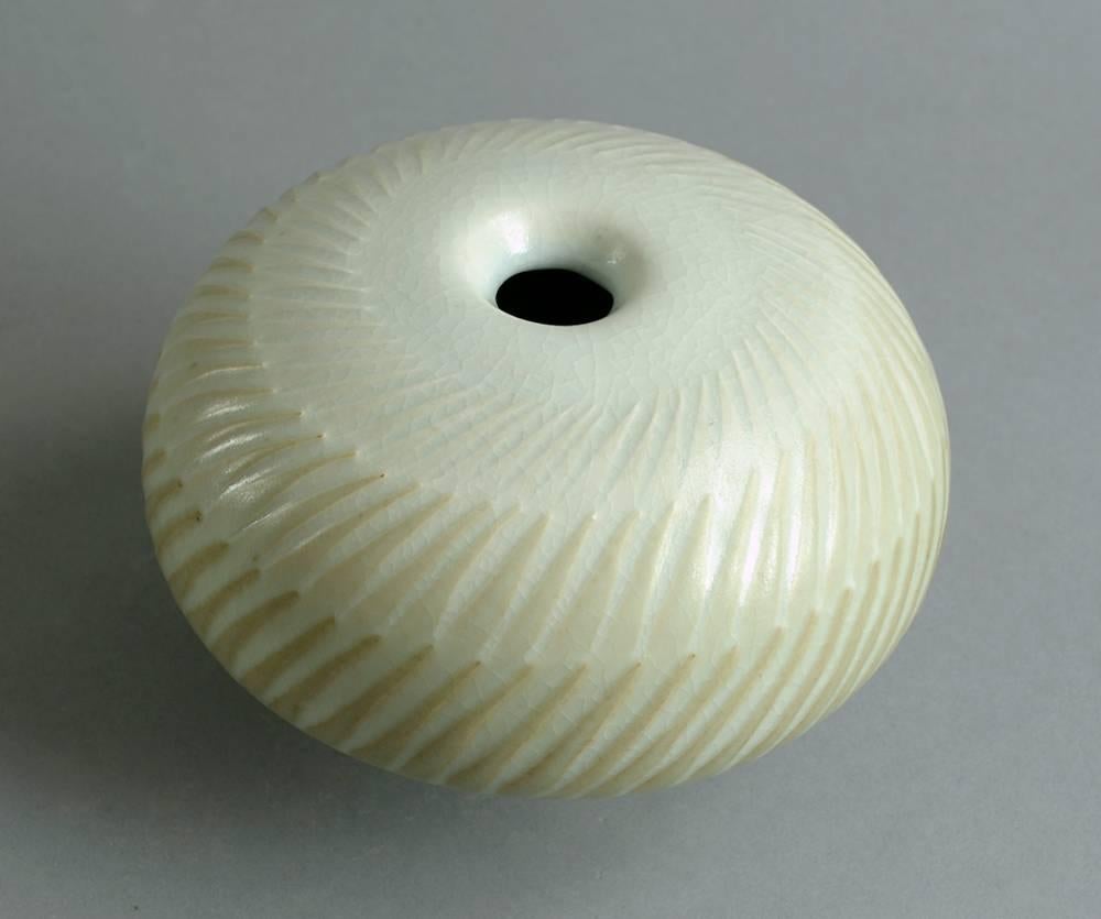Karl Scheid, own studio, Germany.
Unique stoneware sculptural vessel with semi matte white glaze and carved pattern to surface, 1983.
Measures: Height 4" (10 cm) width 6" (15 cm).
Impressed "Scheid HH 83."
Excellent