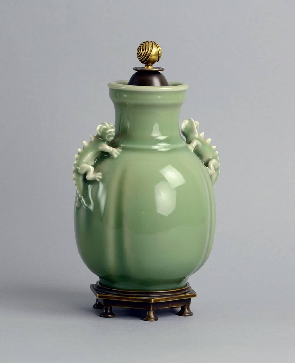 Bode Willumsen for Royal Copenhagen, Denmark.
Unique stoneware lidded jar with applied dragon handles and glossy celadon glaze. Lid by Knud Andersen, 1930s.
Measures: Height 10
