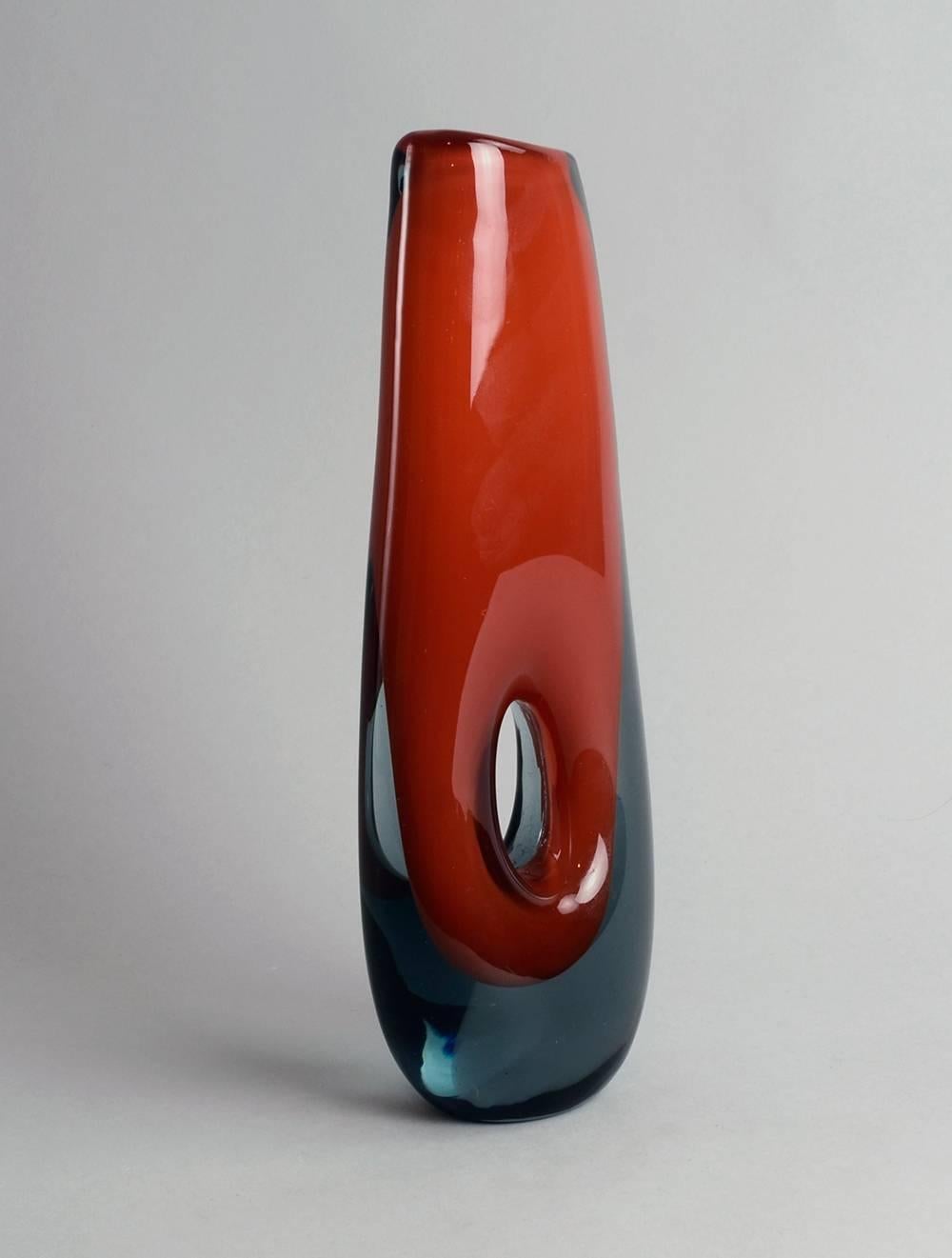 Vicke Lindstrand for Kosta, Sweden.
Unique handblown pierced "Sommerso" vase in gray and orange-red glass, circa 1955.
Measures: Height 11" (27.5cm), width 3 1/2" (9cm).
Engraved "Kosta LH 1321/69"
No.