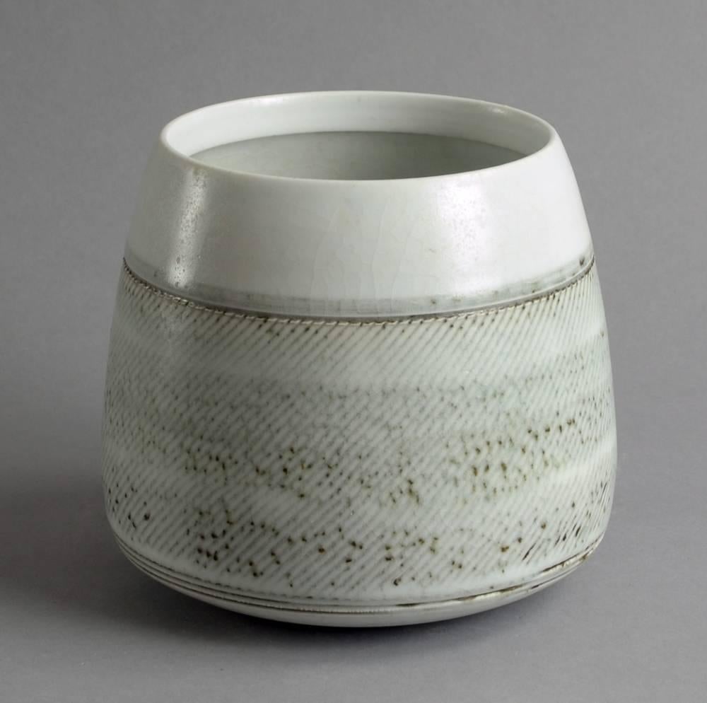 Ulfert Hillers, own studio, Germany
Stoneware vase with matte gray glaze with line pattern to exterior, 1986.
Height 5 3/4