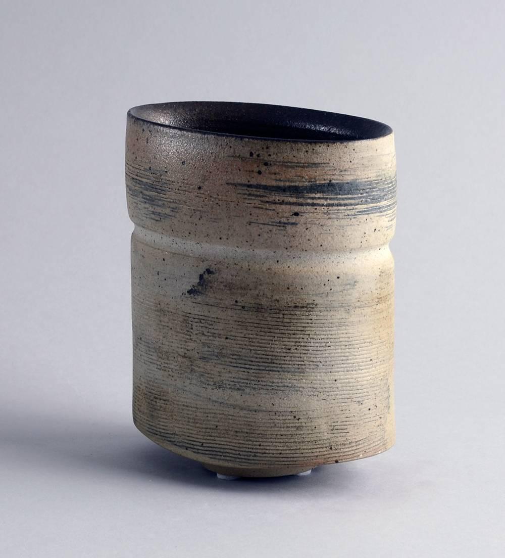 Fritz Vehring, own studio, Germany

Unique stoneware vase with matte beige, gray and black glaze and incised horizontal grooves to exterior, 1983.
Measures: Height 5 1/2