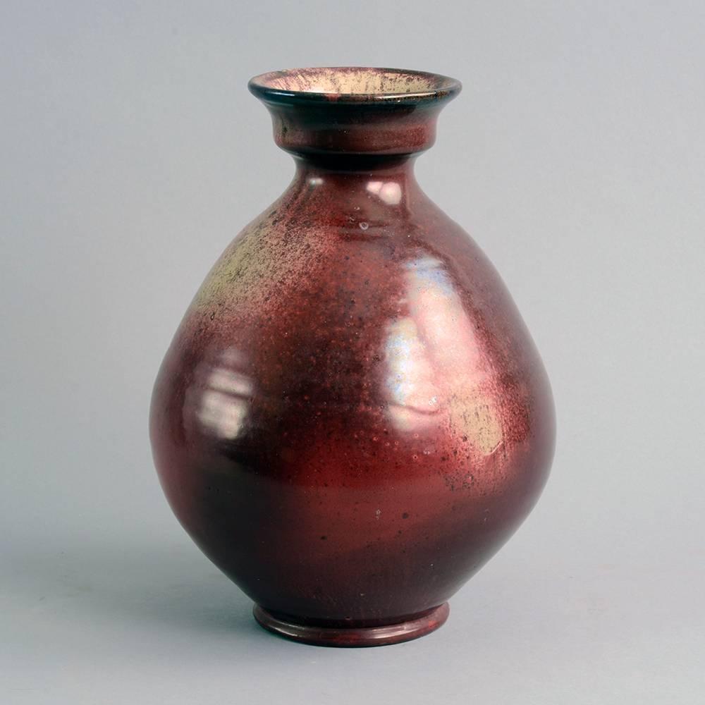 Herman A. Kahler Keramik, Denmark.
Earthenware vase with glossy red and beige glaze, 1920s-1930s.
Height 10 1/4