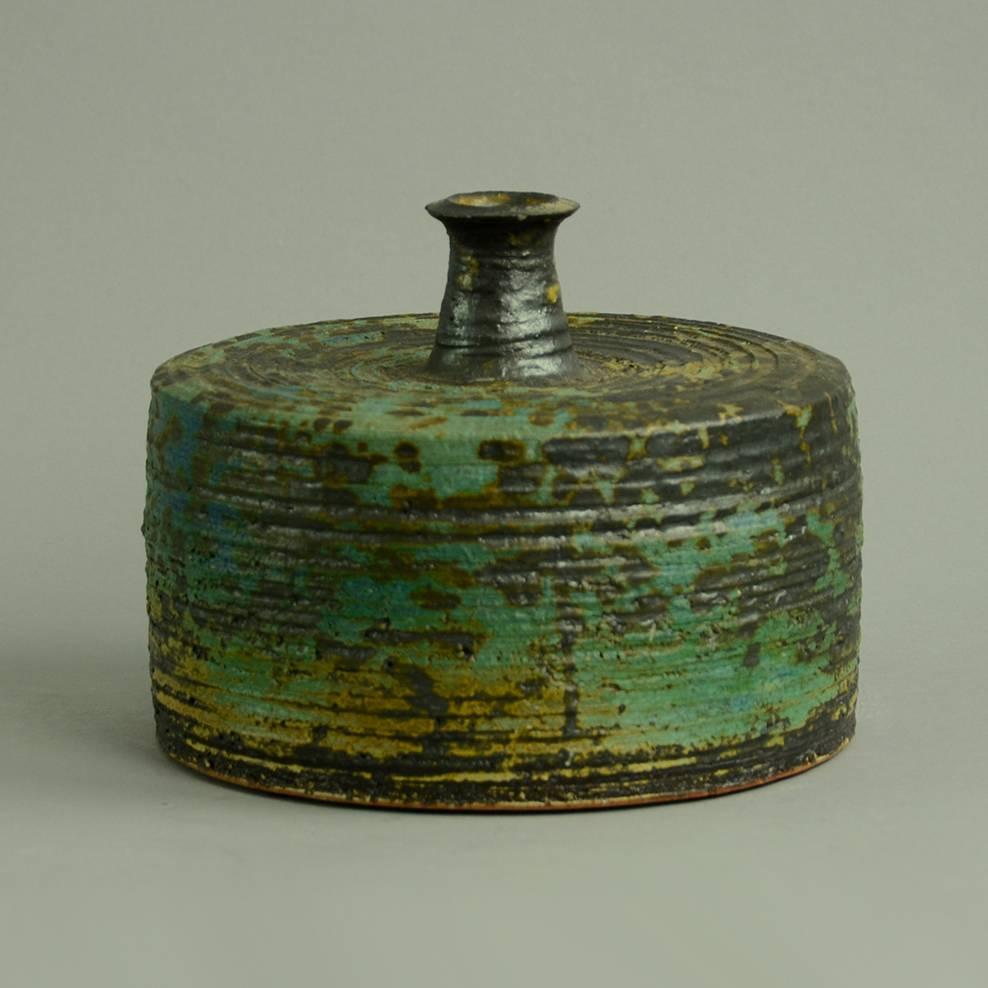 Annikki Hovisaari for Arabia

Unique stoneware cylindrical bottle vase with turquoise and dark brown matte glaze, 1960s.
Incised 