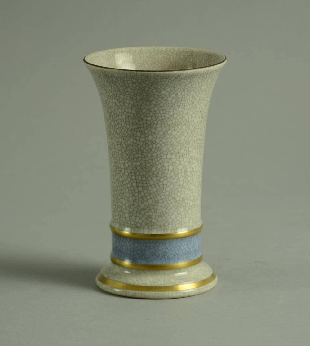 Wide mouthed vase with blue and grey crackle glaze, gold leaf accents, 1949.
Measures: Height 5 3/4