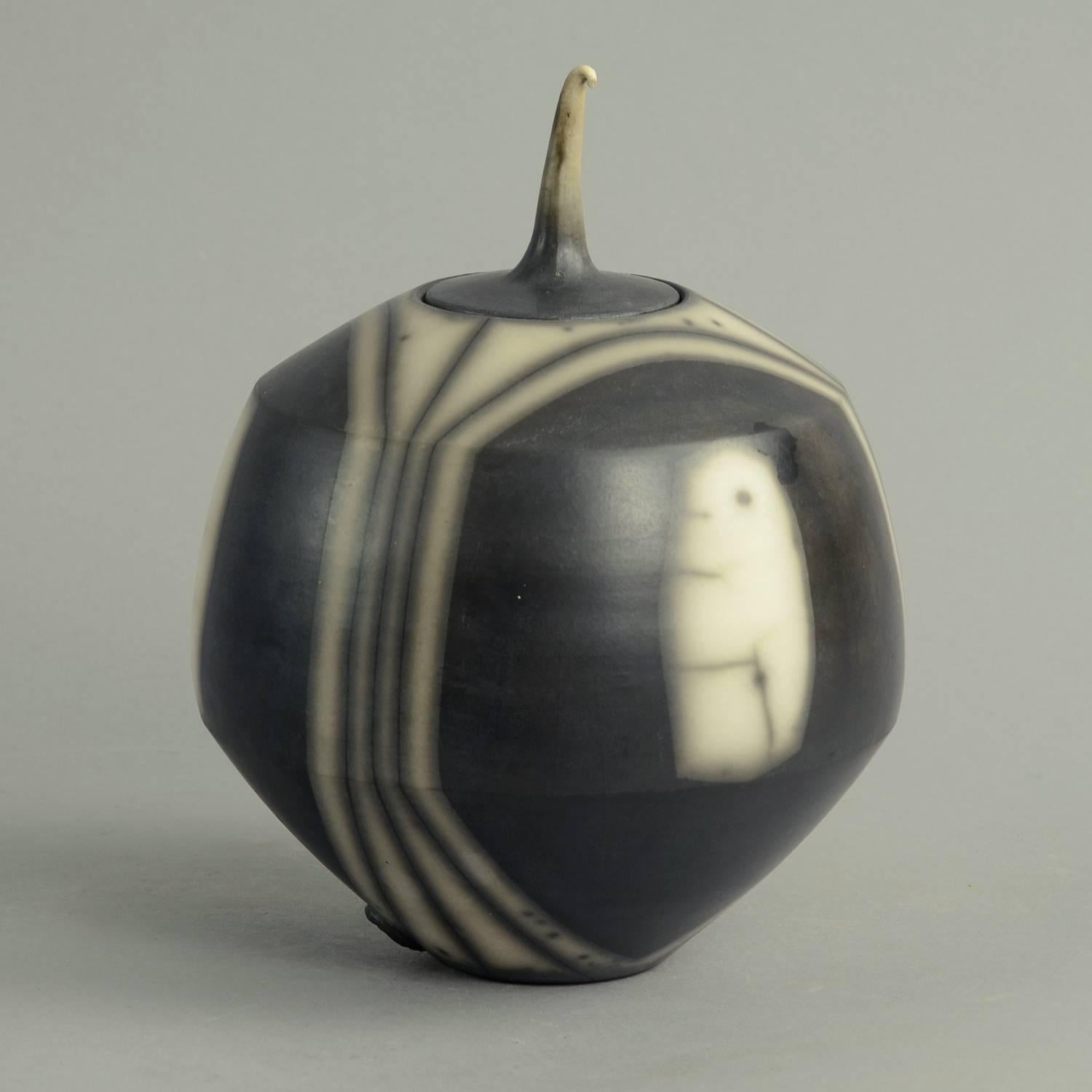 Tim Andrews, own studio, UK.

Unique, smoke-fired, burnished stoneware raku lidded jar in black and white slip.
Measures: Height 8 1/2