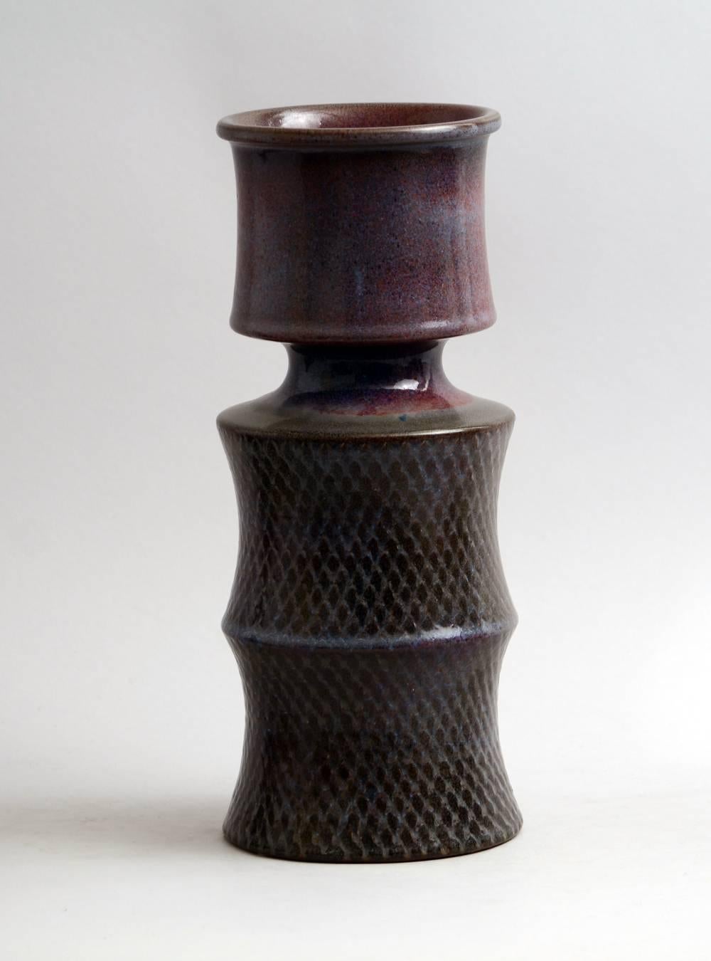 Stig Lindberg for Gustavsberg, Sweden

Unique stoneware vase with purple glossy glaze and impressed pattern to body, 1969.
Measures: Height 13 1/4