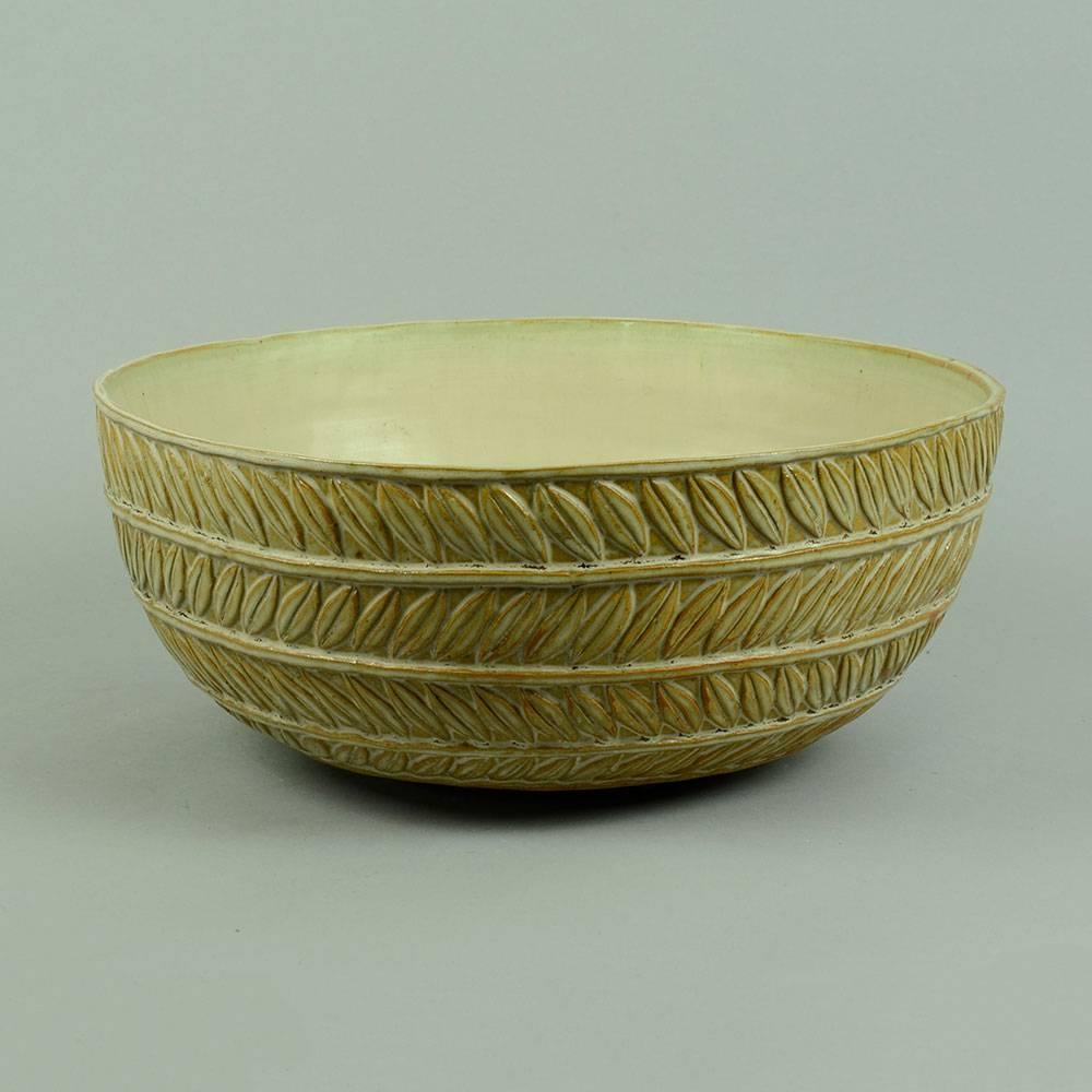 Axel Salto for Royal Copenhagen, Denmark

Very large stoneware bowl with leaf decoration to exterior, matte cream glaze, signed and dated 1936.
Measures: Height 5 3/4