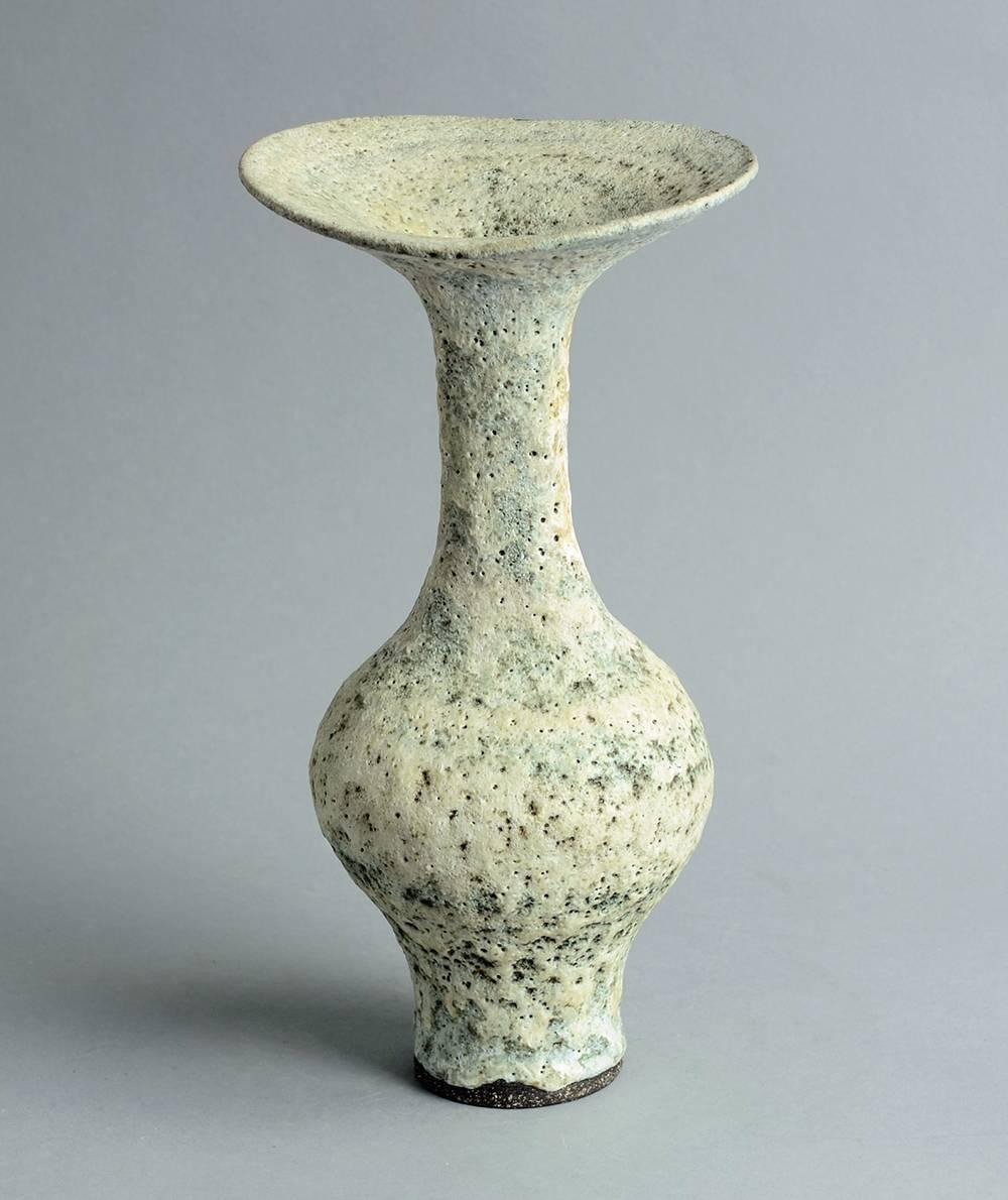 Unique stoneware vase with cream and gray volcanic glaze.